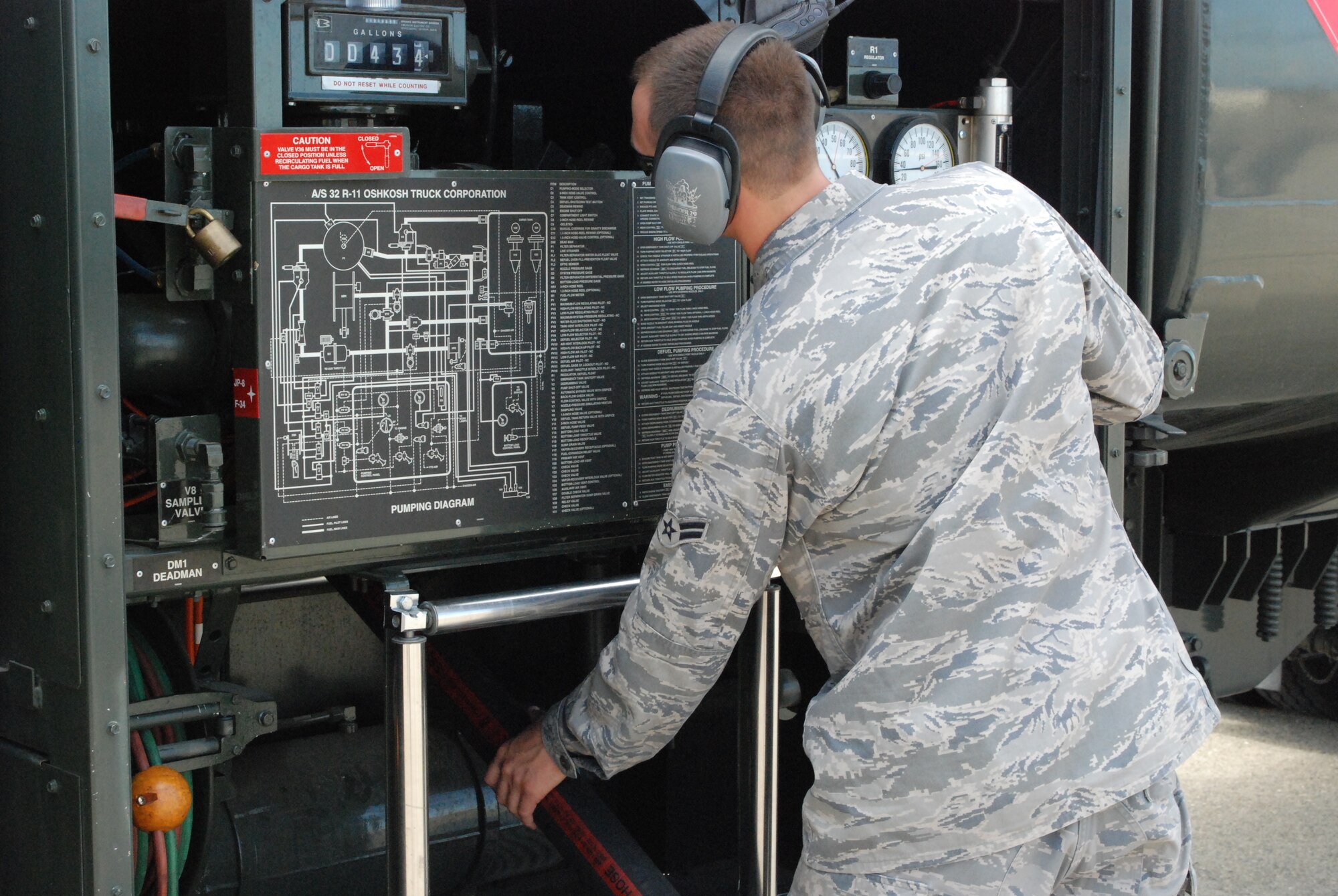 Airman 1st Class Andrew Taylor, 9th Logistics Readiness Squadron, adjusts a fuel hose while filling a T-38 Talon aircraft May 6 on the flightline. The flight uses 12 vehicles to refuel aircraft and service stations around base. (Photo by Airman 1st Class Chuck Broadway)