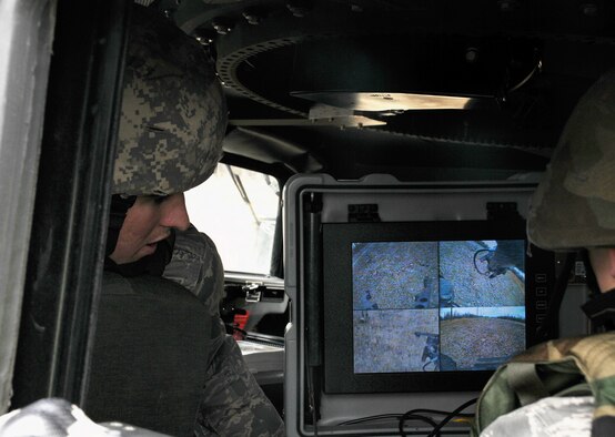 Airman Devin Long views a laptop controller May 5 at Eielson Air Force Base, Alaska. The controller allows personnel to manipulate the Talon, a tactical robot, from a safe distance of explosives. Airman Long is an explosive ordnance disposal apprentice with the 354th Civil Engineer Squadron Explosive Ordnance Flight. (U.S. Air Force photo/Airman 1st Class Laura Max) 