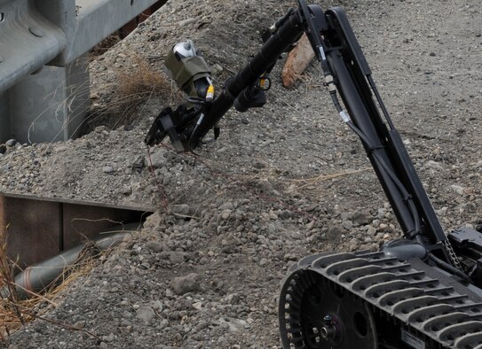 A Talon tactical robot de-arms a simulated improvised explosive devise during a readiness exercise May 5 at Eielson Air Force Base, Alaska. The Talon is a tactical robot that personnel can use to de-arm explosives from a safe distance. (U.S. Air Force photo/Airman 1st Class Laura Max)
