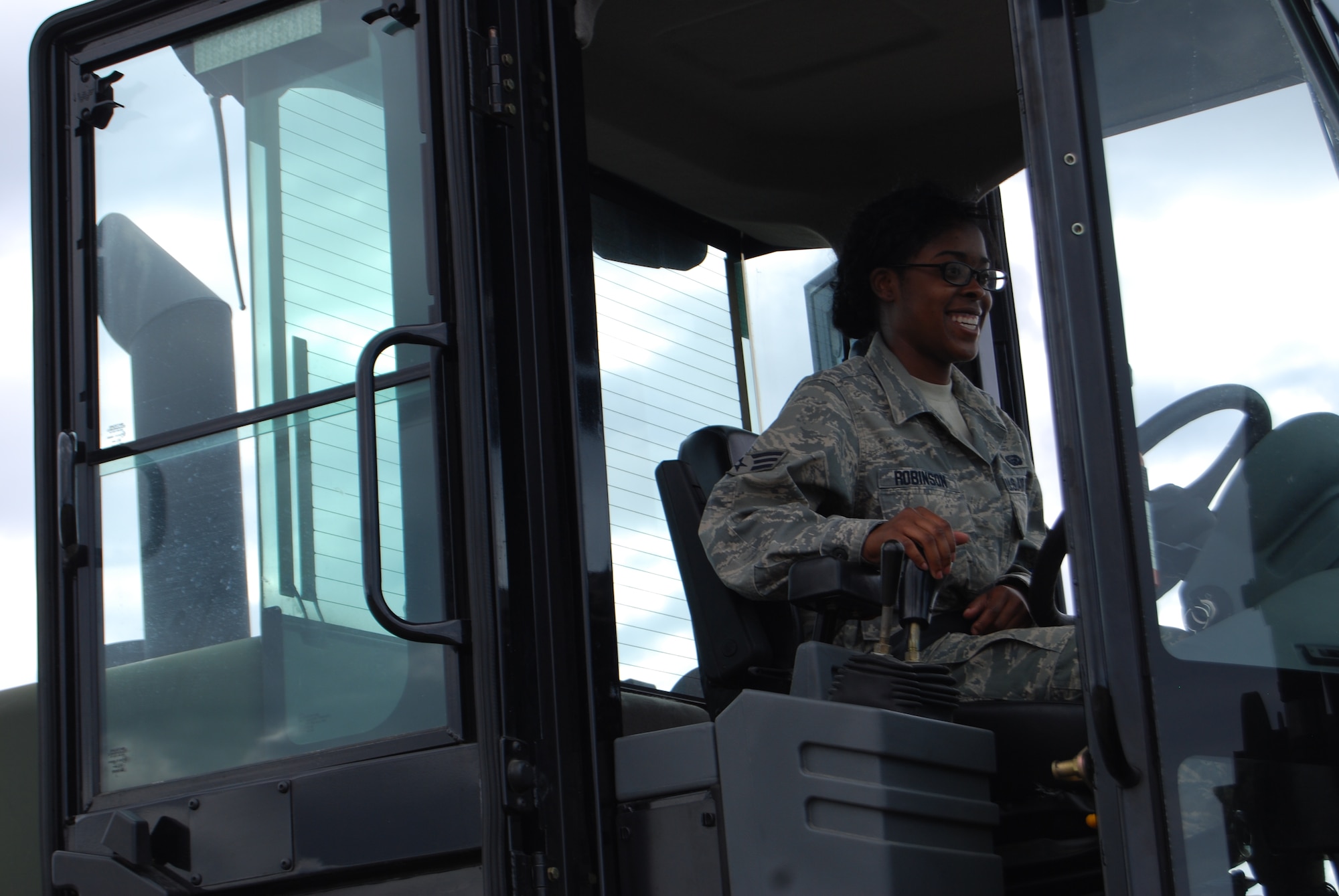 An excited Senior Airman Ebony Robinson successfully drove a 10K forklift in Aguadilla, Puerto Rico as part of her training with the 433rd Airlift Control Flight. Airman Robinson, primarily a personnel specialist,  had a successful mission during Patriot Hoover 2009. As part of the 433rd Airlift Wing's ALCF, she has to learn tasks well outside of her specialty. She also marshalled two C-17s and learned to run a load bank to power the MARRC, or Mobile Airfield Radio Reporting Communication shelter. (U.S. Air Force Photo/Staff Sgt. Carlos Trevino)
