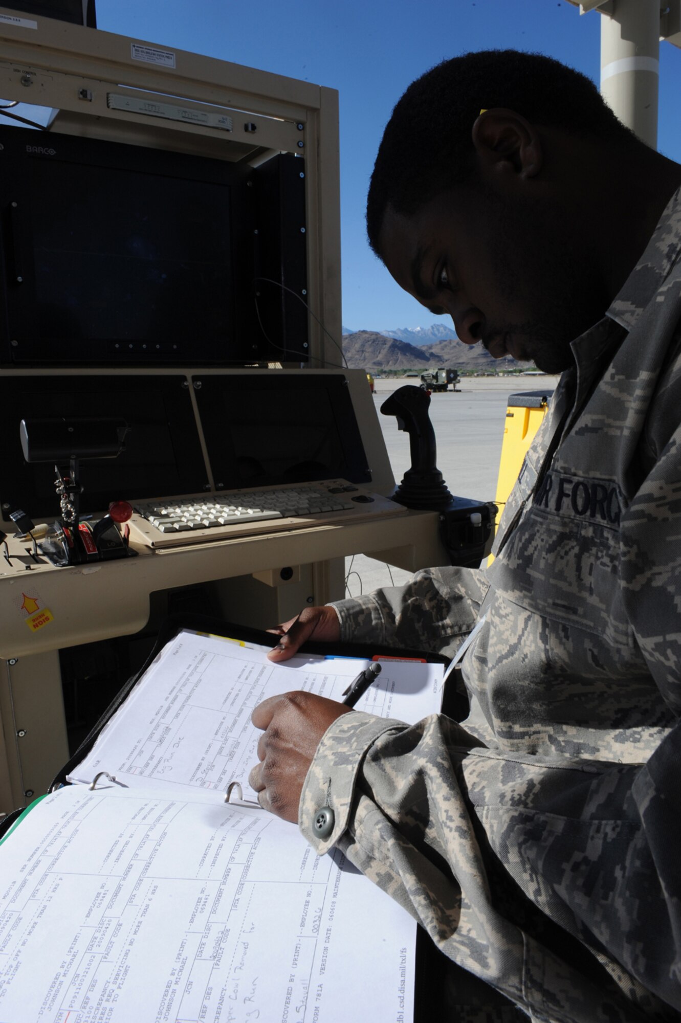 CREECH AFB, Nev. -- Senior Airman David Stovall, MQ-1 Predator crew chief with the 432d Aircraft Maintenance Squadron, makes annotations on forms after running an engine diagnostics test, April 22. (U.S. Air Force photo by/Senior Airman Nadine Y. Barclay)