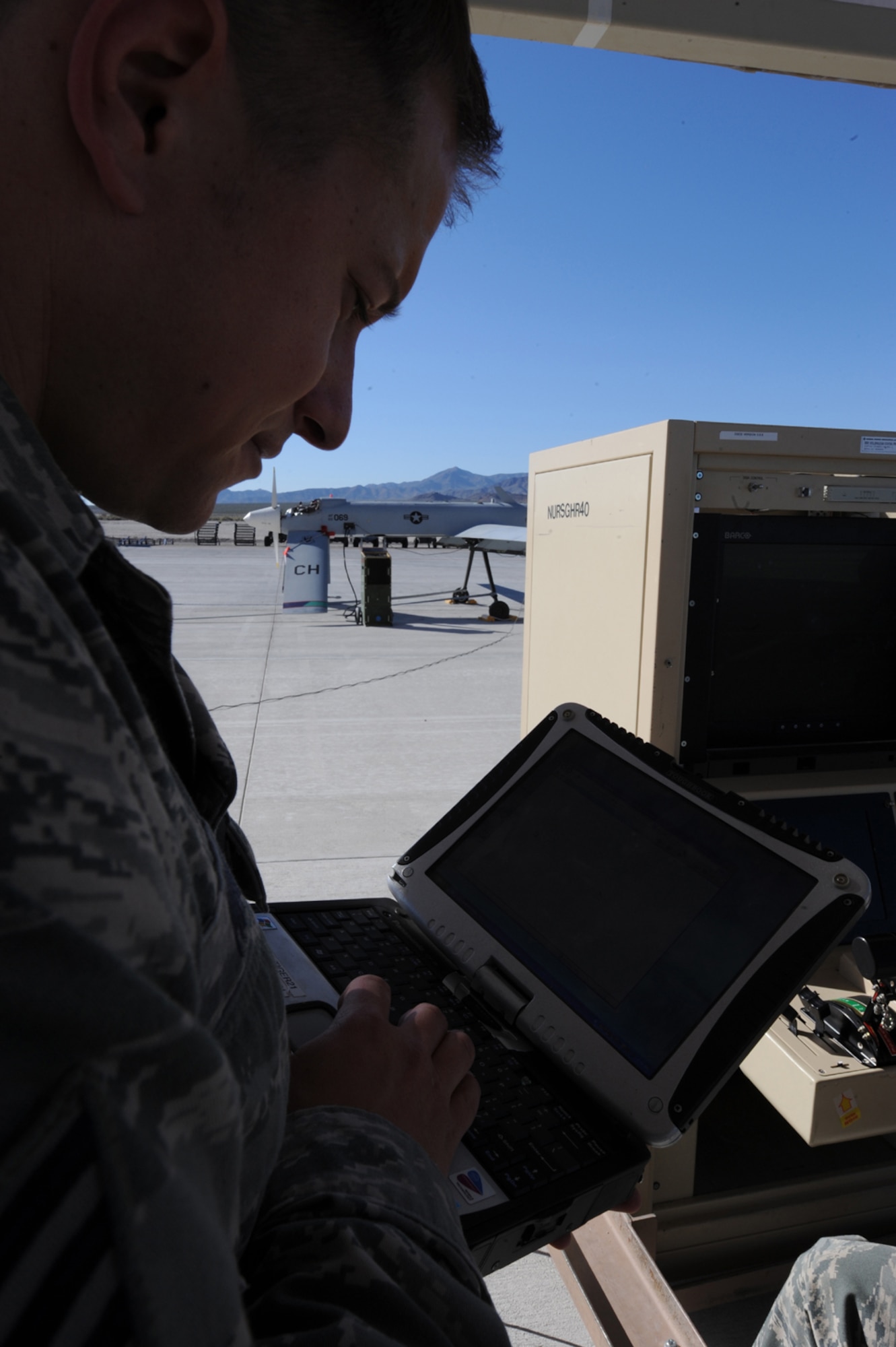 CREECH AFB, Nev. -- Staff Sgt. Theodore Muto, a MQ-1B Predator crew chief assigned to the 432d Aircraft Maintenance Squadron, evaluates data from an engine run on an MQ-1B Predator, April 22. Predator crew chiefs are required to attend an engine running class to  maintain certifications as part of a pre-deployment checklist.(U.S. Air Force photo by/Senior Airman Nadine Y. Barclay)