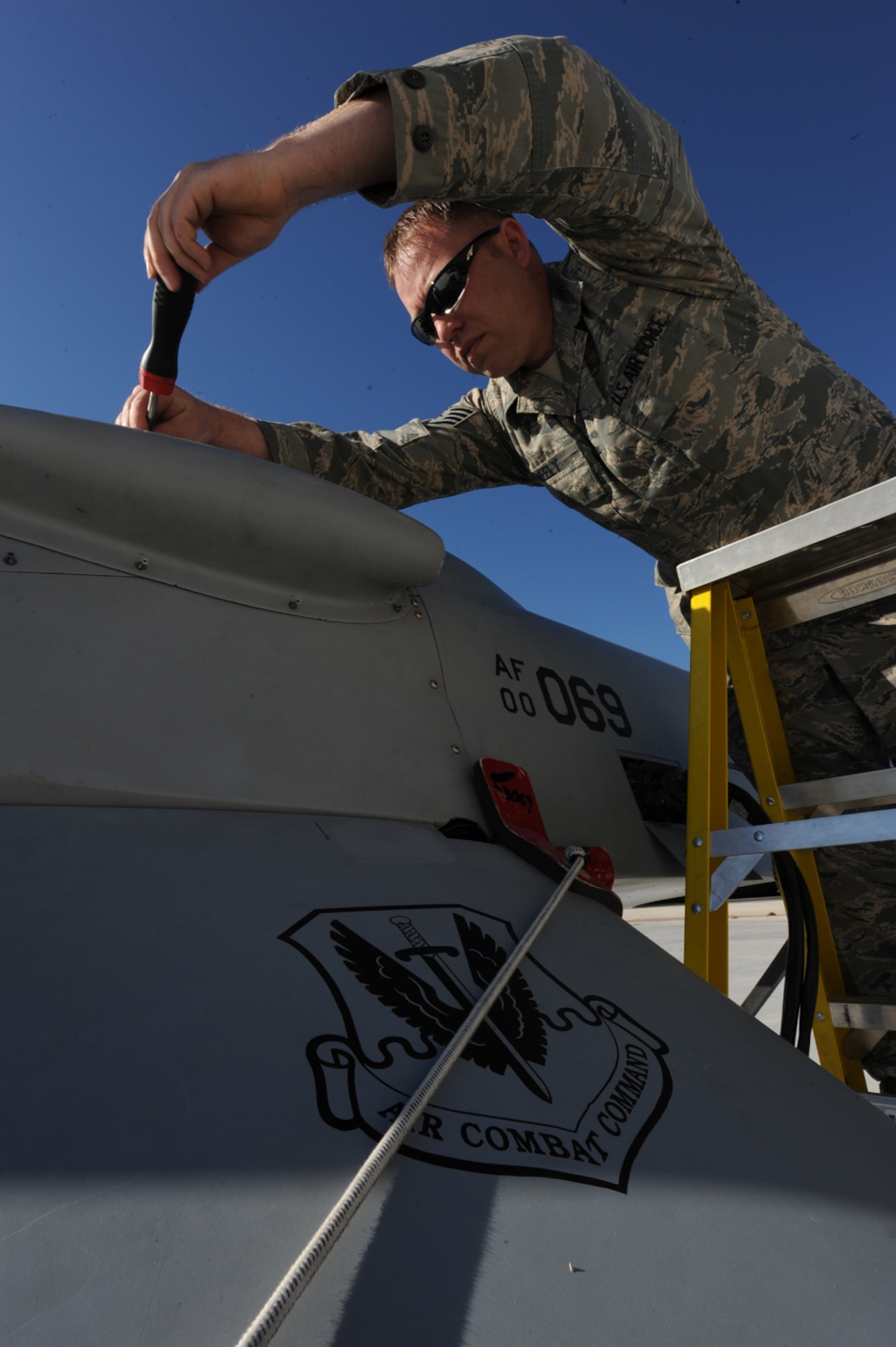 CREECH AFB, Nev. -- Staff Sgt. William Neely, a MQ-1B Predator crew chief with the 432d Aircraft Maintenance Squadron, prepares a Predator for an engine diagnostics class by removing an engine panel, April 22. (U.S. Air Force photo by/Senior Airman Nadine Y. Barclay)