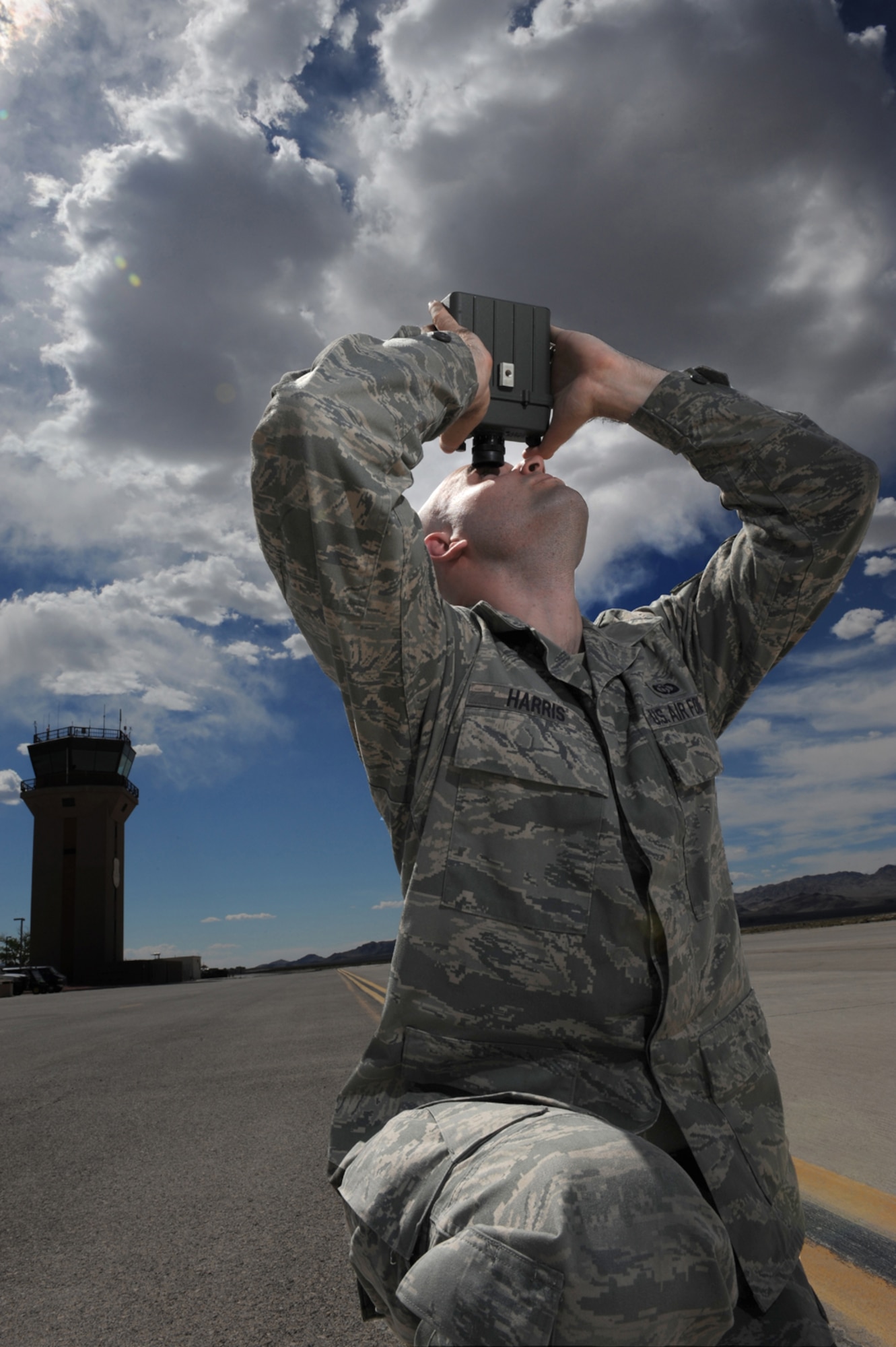 CREECH AFB, Nev. -- Senior Airman Daniel Harris, an Unmanned Aircraft Systems weather forecaster, assigned to the 432d Operations Support Squadron Weather Flight, locates the tops and bases of the clouds utilizing a laser range finder, as part of weather observations for flying missions at Creech, April 22. (U.S. Air Force photo/Senior Airman Larry E. Reid Jr.)