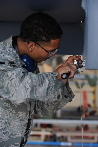 CREECH AFB, Nev. -- Senior Airman Gale Passe, a MQ-9 Reaper weapons loader assigned to the 432d Aircraft Maintenance Squadron, prepares to load a AGM-114 Hellfire II missile on the MQ-9 during weapons load training at Creech April 22. (U.S. Air Force photo by/Senior Airman Nadine Y. Barclay)