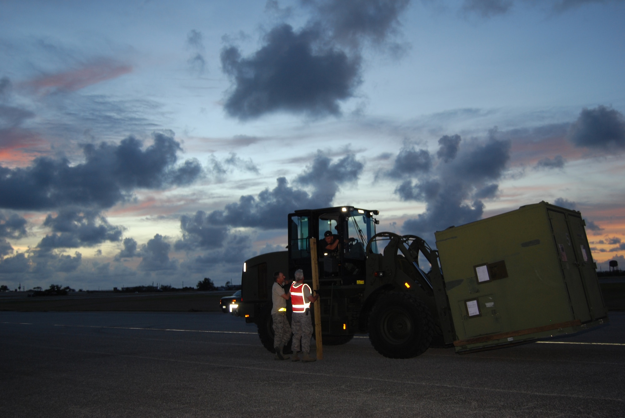 Senior Airman Allen Colston, a 433rd Airlift Control Flight Airman, stops his 10K forklift to talk to Senior Master Sgt. Scott Bishop and Master Sgt. Charlie Callahan during an offload of a C-5.  Airman Colston, a communication airman, was in Aguadilla, Puerto Rico to participate in Patriot Hoover 2009, April 30 to May 4. (U.S. Air Force Photo/Staff Sgt. Carlos Trevino)