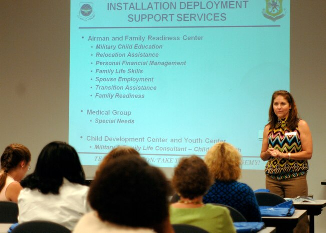 Elsa Summers briefs representatives from tri-county area schools as part of the Counselors Understanding Deployment Operations program in the logistics readiness squadron classroom May 5. The “mock deployment line” was devised to assist school counselors in understanding and helping children with deployed parents. Ms. Summers is a community readiness consultant and school liaison with the Airman and Family Readiness Center. (U.S. Air Force photo/Senior Airman Timothy Taylor)