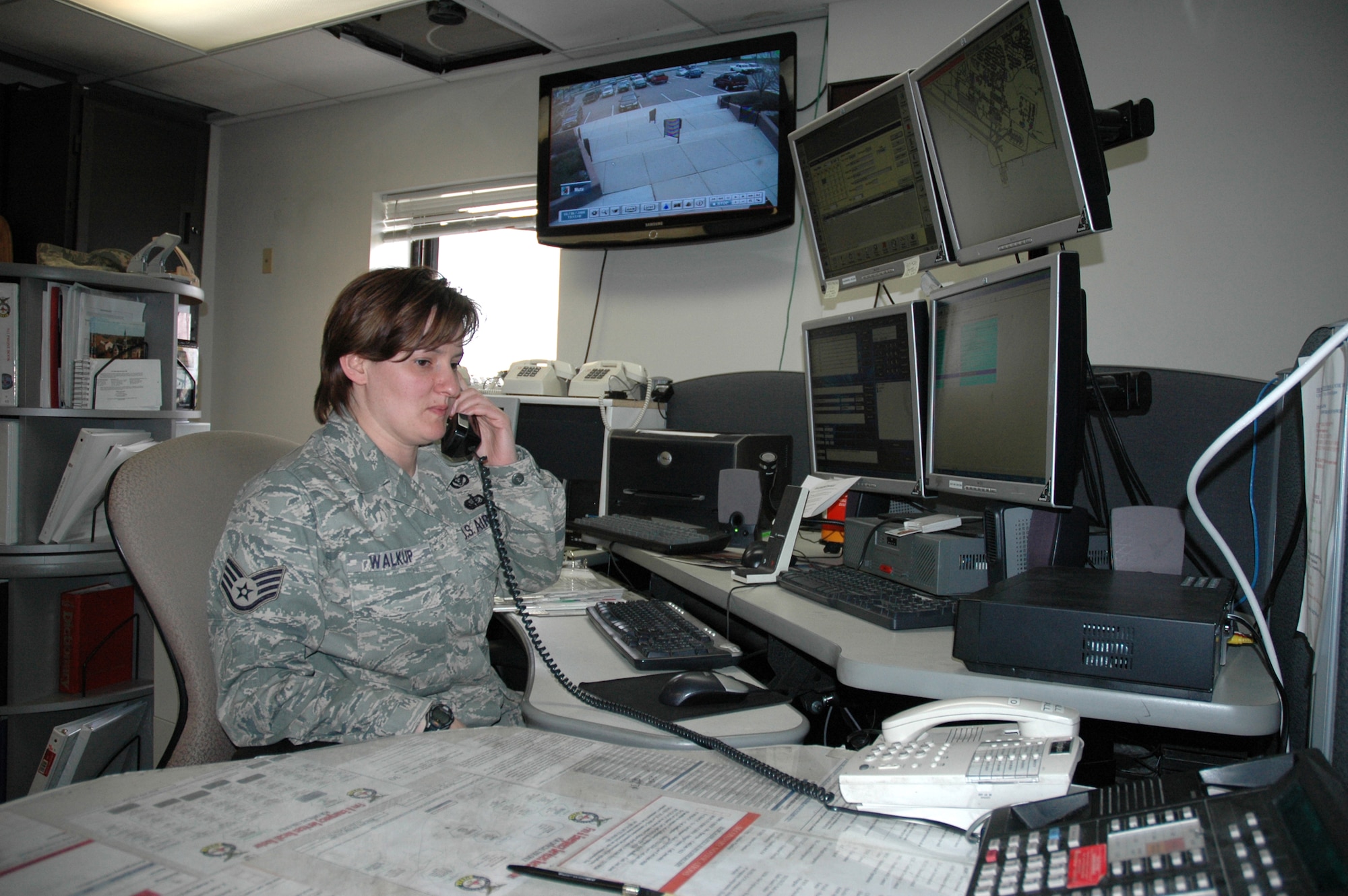 MINOT AIR FORCE BASE, N.D. -- Staff Sgt. Sherry Walkup, 5th Civil Engineer Squadron alarm room dispatcher fields a phone call at the emergency dispatch center here May 5. The EDC is the frontline of response and assistance for many emergency situations on the base. (U.S. Air Force photo by Senior Airman Wesley Wright)