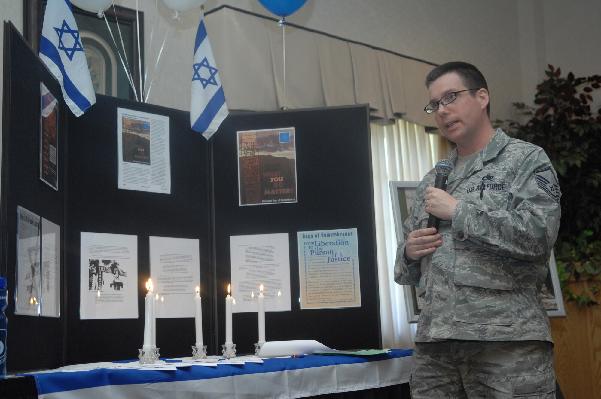 MINOT AIR FORCE BASE, N.D. - Master Sgt. Louis Marin, 5th Maintenance Squadron production superintendant, talks about the remembrance of holocaust victims at a cultural fair here May 1. This was the base's first annual cultural fair and was developed as a means to celebrate and recognize the diversity of all cultural groups. (U.S. Air Force Photo by Staff Sgt. Stacy Moless)
