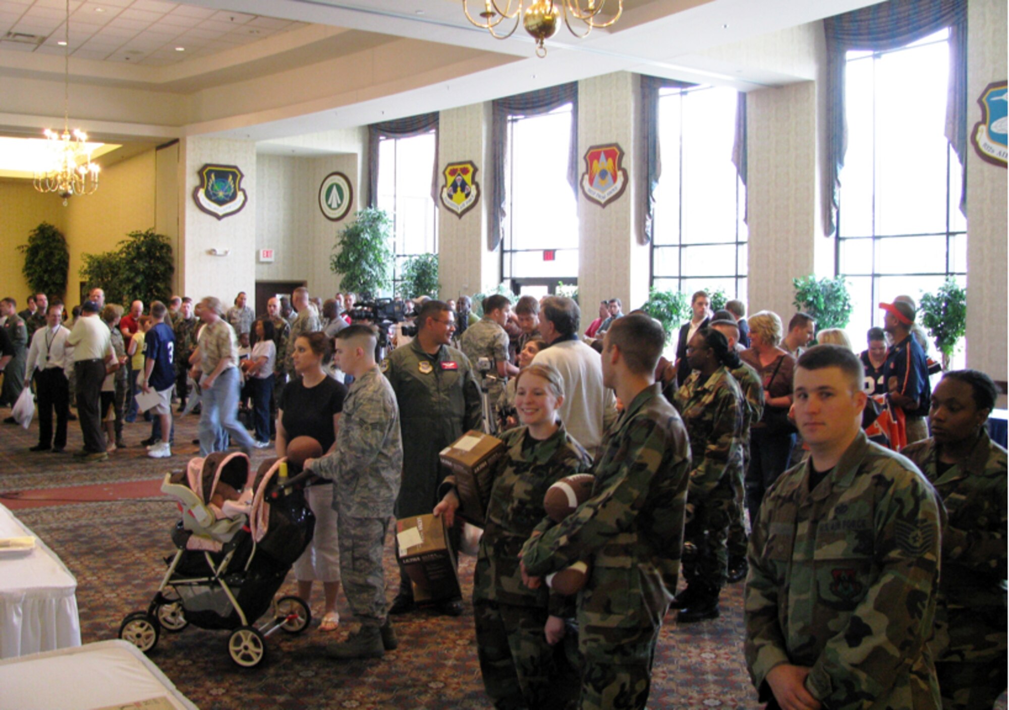 A crowd gathers at Scott Air Force Base, Ill., to meet and greet NCAA football coaches participating in Coaches Tour 2008, a morale-boosting mission designed to bring the coaches to troops overseas. The Coaches Tour 2009 stateside meet and greet is scheduled to include Air Force coach Troy Calhoun, Wake Forest coach Jim Grobe, and Ohio State coach Jim Tressel at McConnell Air Force Base, Kan. on May 28. (Courtesy photo)
