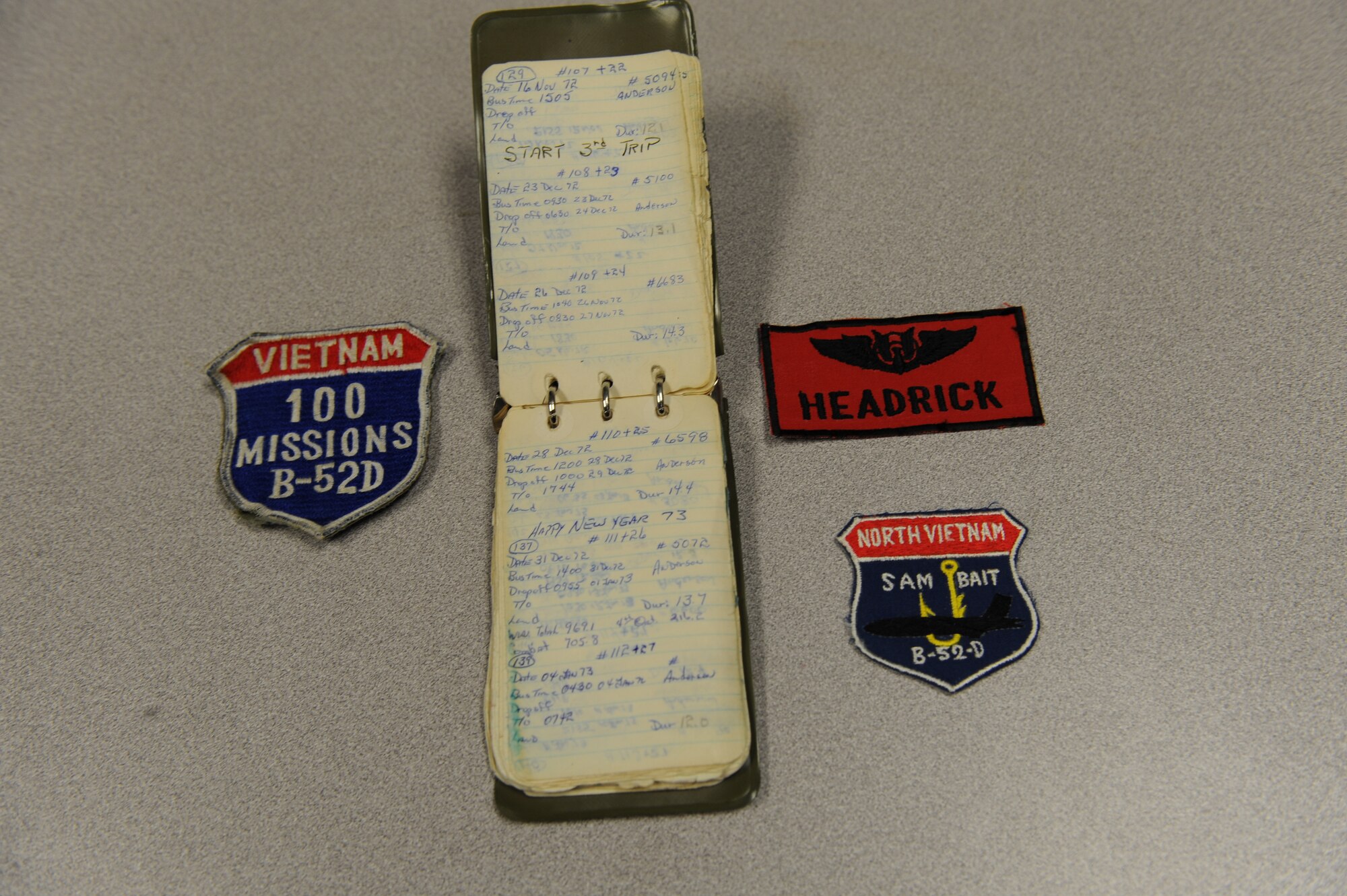 WHITEMAN AIR FORCE BASE, Mo. – An arrangement of flight patches and a flight log maintained by retired Master Sgt. Jerry Headrick, a former B-52 tail gunner.   Mr. Headrick flew 2000 combat hours and was awarded 10 Distinguished Flying Crosses during the Vietnam War. (US Air Force Photo/Senior Airman Jason Huddleston)  