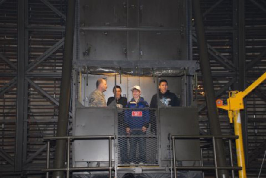 Master Sgt. Rob Gingery, superindentant of the Alaska Radar System, shows visiting Kaktovik children around the interior of the massive dome housing the Barter Island radar site. (U.S. Air Force photo/1st Lt. John Callahan)