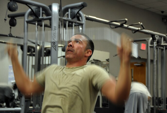 Staff Sgt. Rodney Bonham powers through a 135-pound repetition during an upper body workout on a pull-down resistance cable machine at the Fitness and Sports Center here May 5. In this exercise, Sergeant Bonham focused on strengthening his upper back muscles, rear shoulders and biceps. Exercises like these utilize several major muscle groups and play an important part in effective strength training. Sergeant Bonham is a calibration craftsman with 437th Maintenance Squadron’s precision measurement equipment laboratory. (U.S. Air Force photo/Staff Sgt. Daniel Bowles)