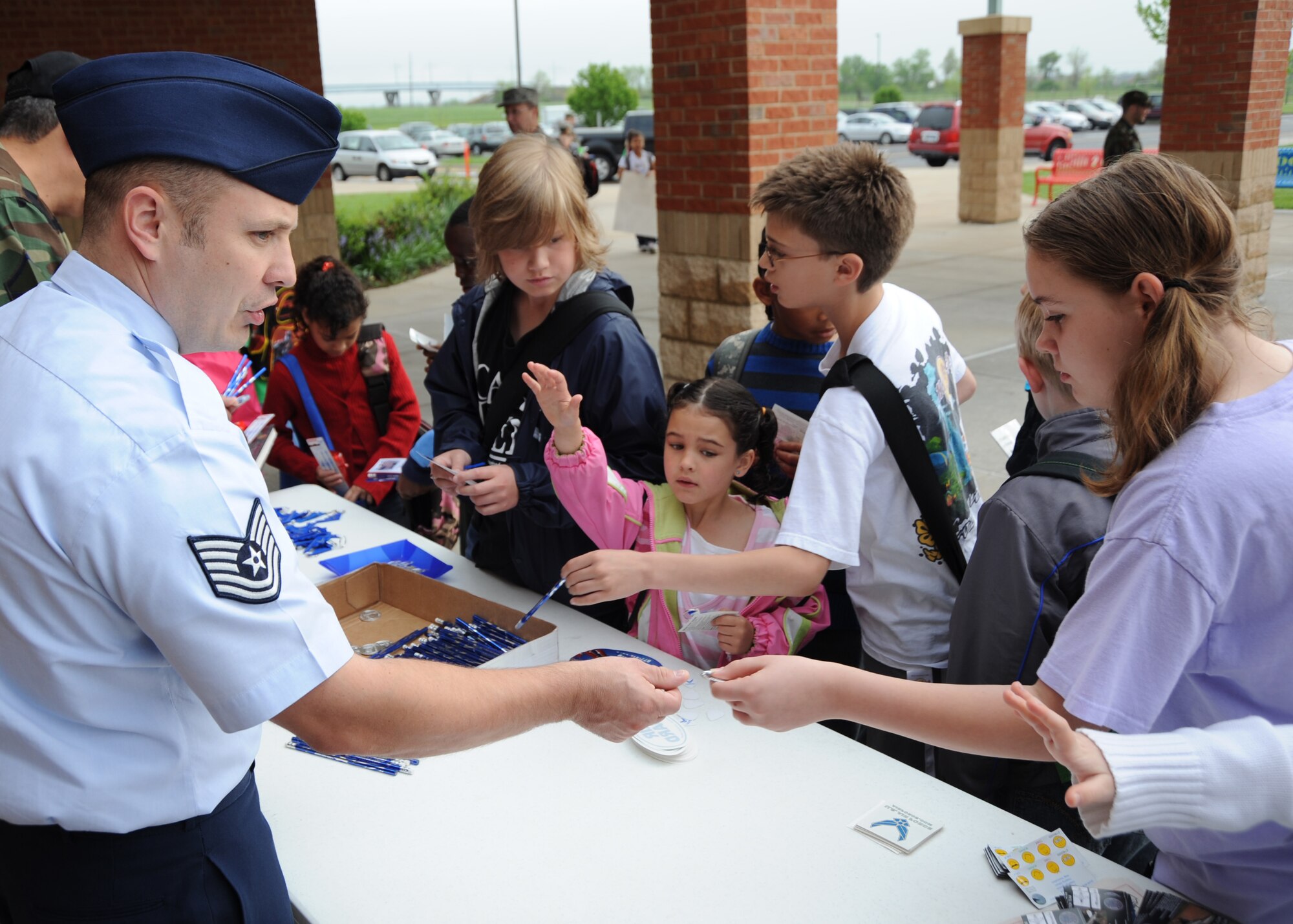 SCOTT AIR FORCE BASE, Ill. --Tech. Sgt. Tim Smith hands out Air Force coins, pencils and stickers to students at Scott Elementary May 1. Sergeant Smith is a recruiter with the 345th Recruiting Squadron.(U.S. Air Force photo/Staff Sgt. Paul Villanueva II) 