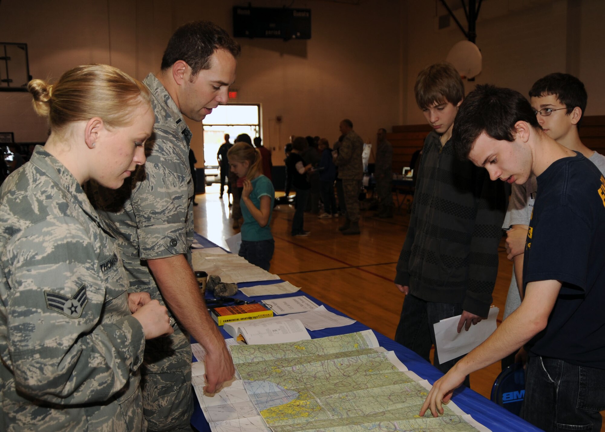 SCOTT AIR FORCE BASE, Ill. --Members of the 375th Operational Support Squadron explain the details of an aircraft navigational map to eighth grade students from Grant Middle School in Fairview Heights, Ill., April 27. The members of the 375th OSS were joined by other Team Scott members for Grant Middle School Career Fair which showcased local community jobs.(U.S. Air Force photo/Airman 1st Class Wesley Farnsworth) 