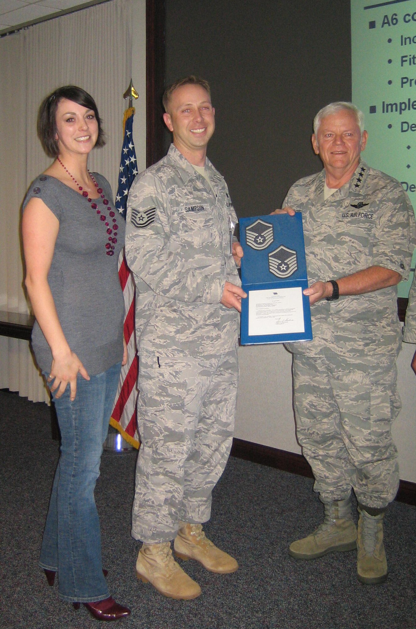 SCOTT AIR FORCE BASE, Ill. --Master Sgt. Dustin Sampson, Headquarters Air Mobility Command Communications, was promoted Tuesday under the Stripes for Exceptional Performers program by Gen. Arthur Lichte, AMC commander, in a surprise meeting.  As the only STEP promotee in all of HQ AMC, this testifies to his outstanding support of Air Mobility Command and the Air Force. His wife, Ila, was also there for the surprise.(U.S. Air Force photo/Senior Airman Megan Gilliland) 