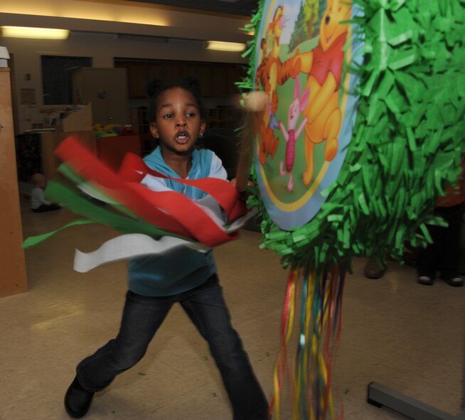 MCCONNELL AIR FORCE BASE, Kan. -- Jahni Kruzelnick, 4 yrs old, daughter of Master Sgt. Brian Kruzelnick, 22nd Aircraft Maintenance Squadron, hits a piñata during the Cinco de Mayo celebration at play group, May 5. Play group is for children, from birth to 5 years, to interact with other children. This time allows parents a chance to socialize with each other and discuss parenting issues. (Photo by Senior Airman Roy Lynch) 