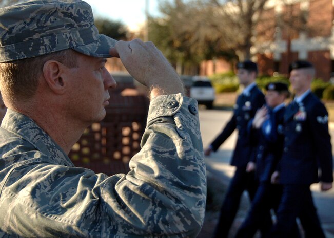 Col. John “Red” Millander salutes as Airmen from the 437th Security Forces Squadron retire the American flag Dec. 15, 2008, during a base retreat ceremony at wing headquarters here. The 437 SFS retired the flag in full service dress while accompanied by civilians and veterans of the Patriot Guard Riders. Colonel Millander currently serves as the 437th Airlift Wing commander. (U.S. Air Force photo/Senior Airman Timothy Taylor)