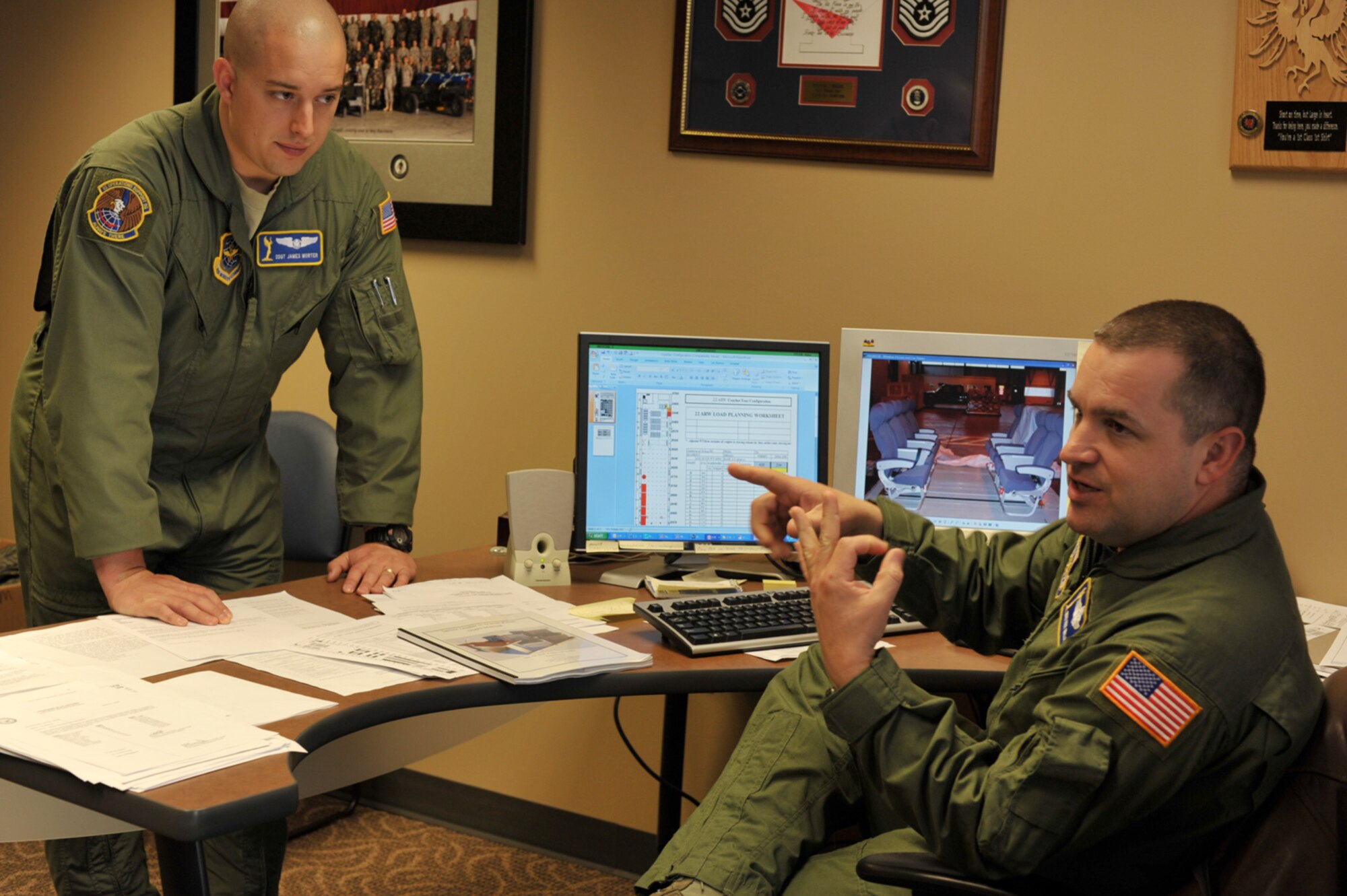 Master Sgt. Paul "Earl" Wallace (on right) and Staff Sgt. James Morter take part in a meeting to discuss the configuration of a KC-135 Stratotanker that will support Coaches Tour 2009, a morale-boosting mission designed to deliver NCAA football coaches to troops overseas. For the second year in a row, tour planners are counting on a KC-135 from McConnell Air Force Base, Kan., for most of their transportation needs. Sergeant Wallace is the standards and evaluation superintendent assigned to the 22nd Operations Group at McConnell. Sergeant Morter is a KC-135 boom operator assigned to the 22nd Operations Support Squadron. (U.S. Air Force photo/Tech. Sgt. Jason Schaap) 
