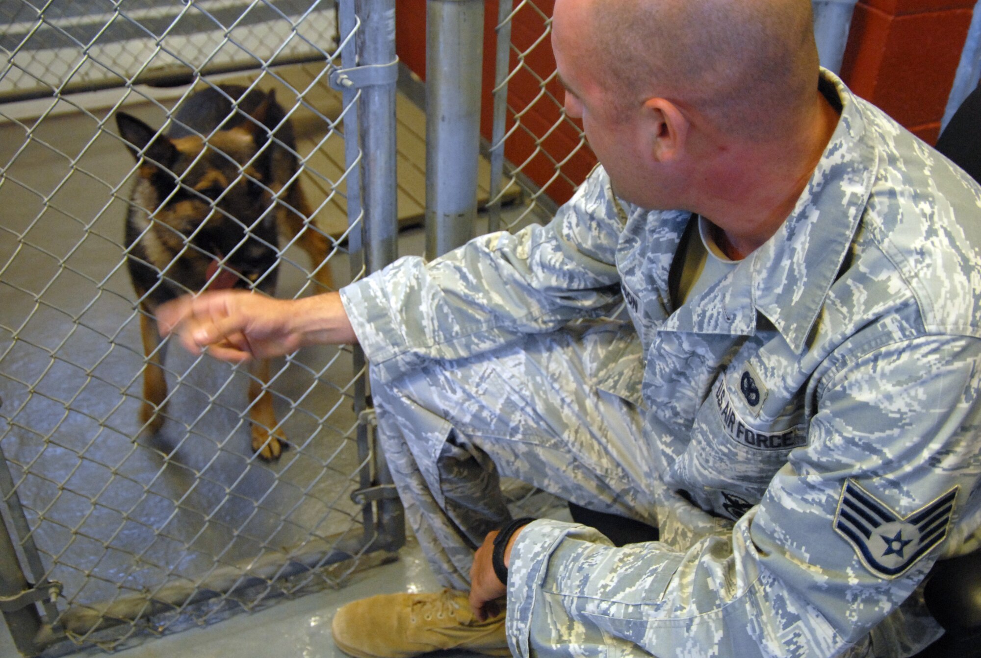 Staff Sgt. Eric Magnuson, 95th Security Forces Squadron Military Working Dog handler, talks to Nix as part of their bonding. The bond between handler and dog is crucial for training and eventually, deployment. (U.S. Air Force photo/Senior Airman Julius Delos Reyes)