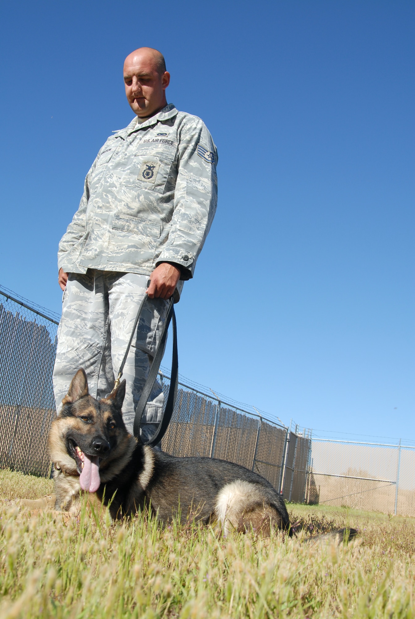 Staff Sgt. Eric Magnuson, 95th Security Forces Squadron Military Working Dog handler, lets Nix take a rest after an exercise. The bond between handler and dog is crucial for training and eventually, deployment. (U.S. Air Force photo/Senior Airman Julius Delos Reyes)