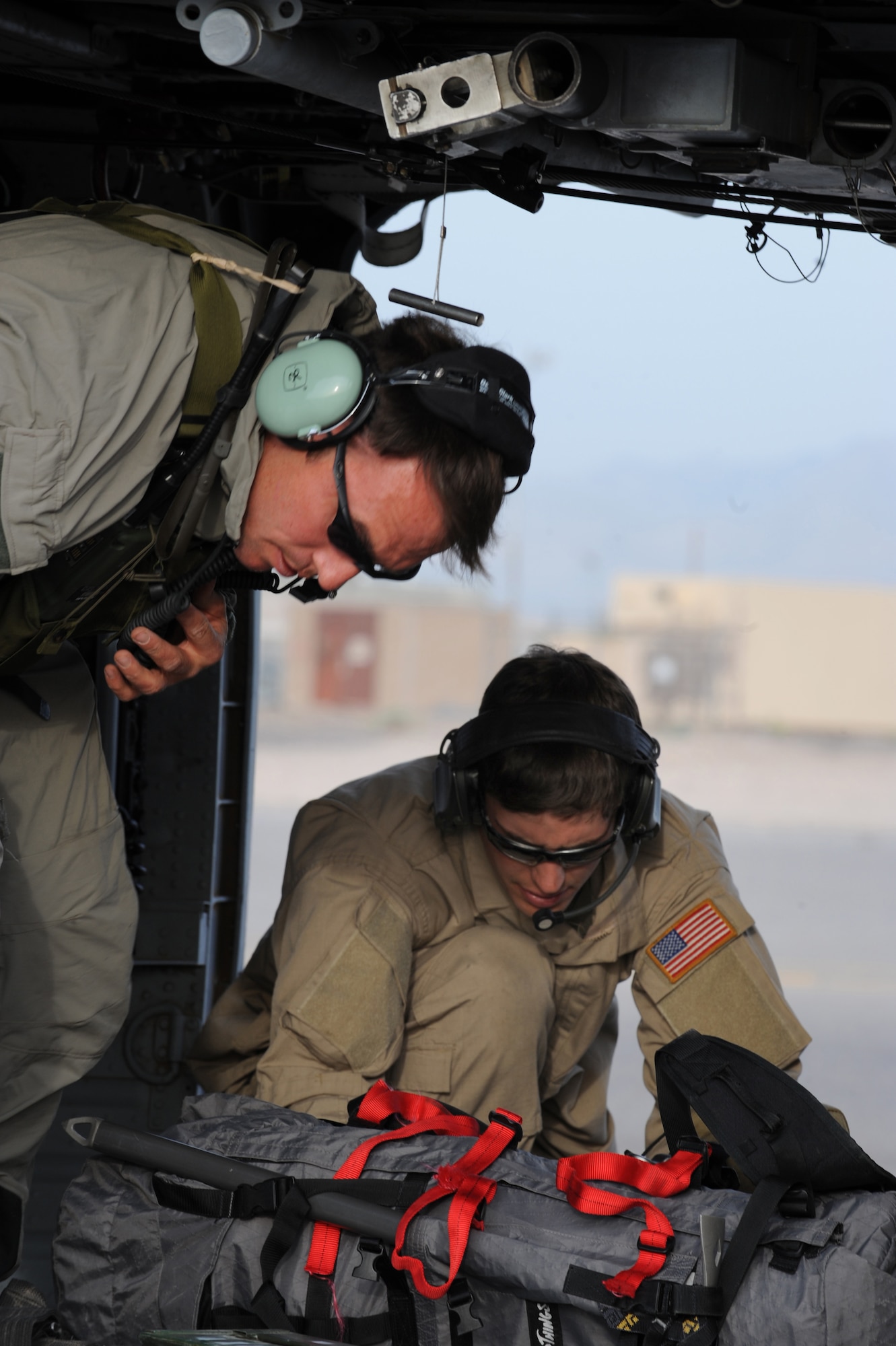 Staff Sgt. Jerry Lennon and Senior Airman David Coval inspect all equipment for discrepancies aboard HH-60G Pave Hawk prior to departing for a rescue mission May 1 at Nellis Air Force Base, Nev. Four helicopters and 24 Airmen from the 58th and 66th Rescue Squadrons deployed to assist in the search for a pilot and passenger who were aboard a motorized sailplane that disappeared from radar April 24 in the Sierra Nevada Mountain Range near Mammoth Lakes, Calif.Sergeant Lenon and Airman coval are pararescuemen with the 58th Rescue Squadron. (U.S. Air Force photo/Senior Airman Nadine Y. Barclay) 
