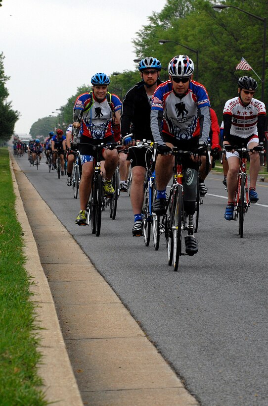 Participants in the wounded warrior soldier ride cycle through the North Gate as they exit Andrews Air Force Base Md., on May 1, 2009. The wounded warriors rode from Andrews to Annapolis, Md., as a part of a four day event to raise awareness of issues that veterans are challenged with when they return wounded from the war and for many, the soldier ride provides an important step in their return to an active lifestyle.(U.S. Air Force photo by Airmen First Class Melissa V. Rodrigues)