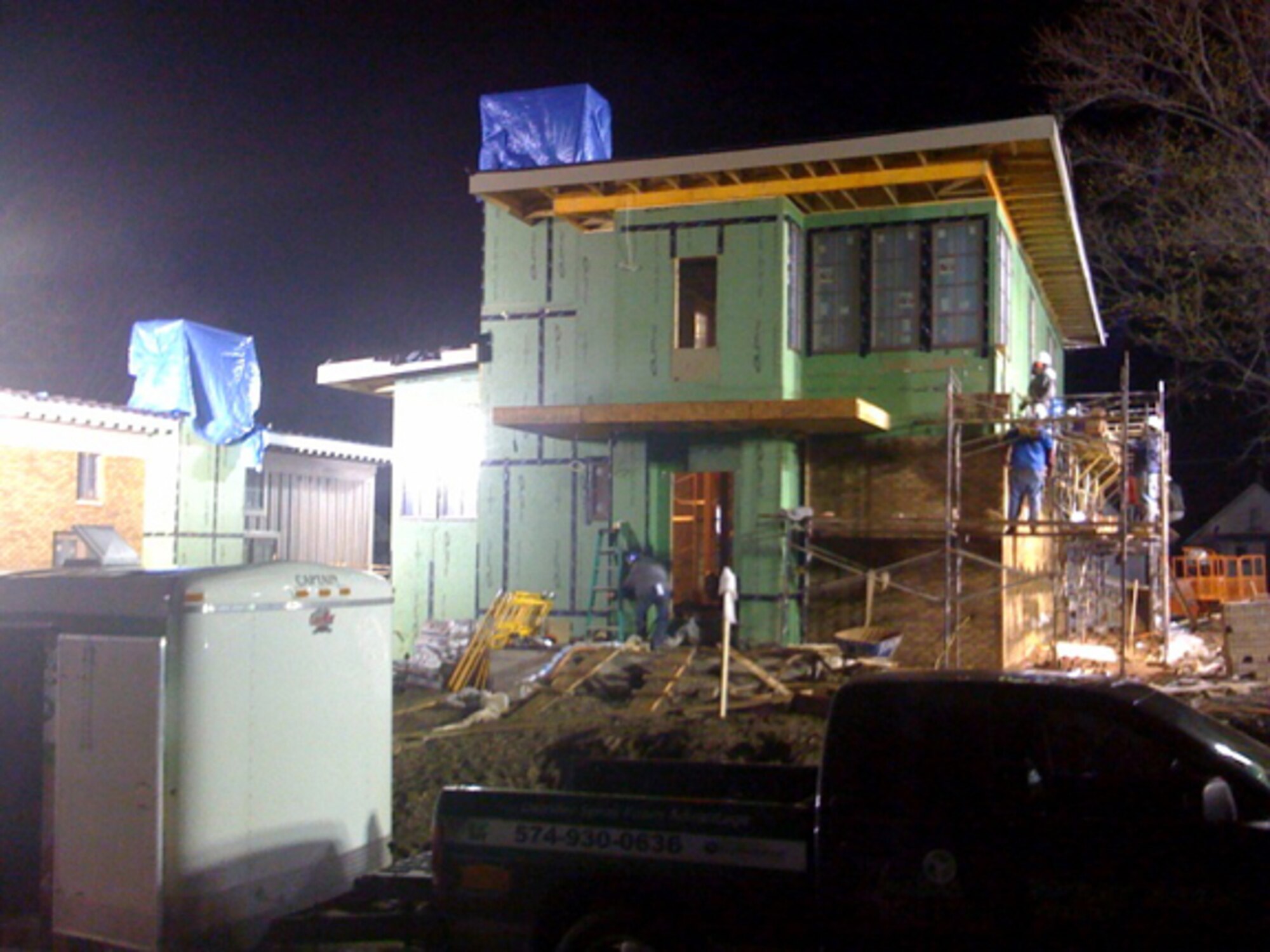 INDIANAPOLIS -- Construction workers and volunteers work through the night for a local family for the television show "Extreme Makeover: Home Edition." Staff Sergeant Chasidy Sells, NCO in charge of 432d Wing Plans and Programs, and Airman 1st Class Troy Spence, 432d Aircraft Maintenance Squadron crew chief, recently volunteered in Indianapolis, Ind. and North Las Vegas, Nev. (Courtesy photo)