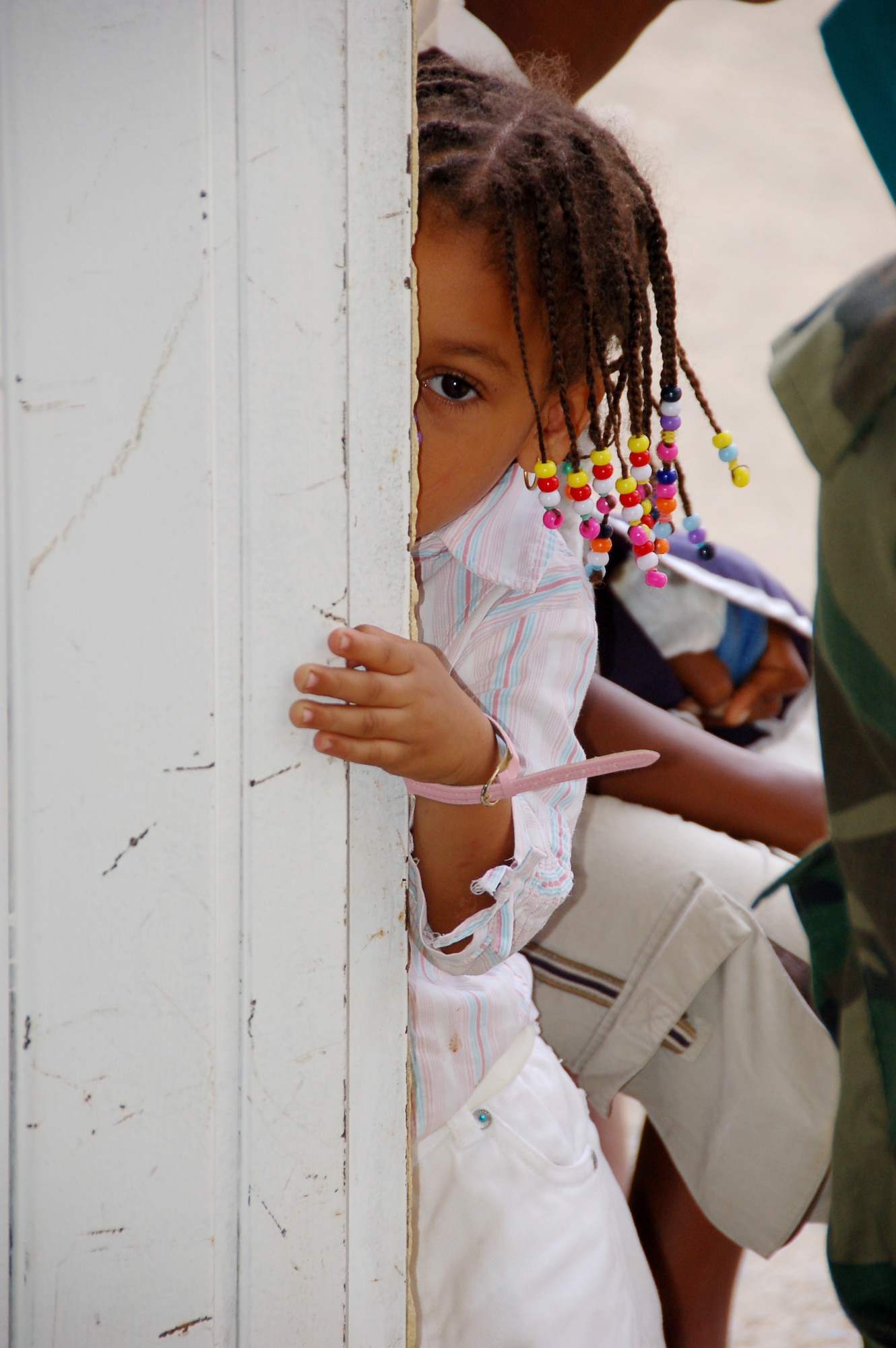 A small child cautiously peers into the pediatrician’s room while awaiting her turn in line at a primary school turned temporary clinic in Hostos, Dom. Rep., April 22, during the largest Maxwell Air Force Base-planned U.S. Air Force Medical Readiness Training Exercise (MEDRETE) to date. A group of 45 medics, translators, security and support personnel derived from the U.S. Air Force, Army and Marines provided dental, dermatologic, general medicine, optometric, pediatric, pharmacy and public health services. The medics treated 2,800 patients during the first three days of the U.S. SOUTHCOM sponsored Beyond the Horizon 2009 – Caribbean. A MEDRETE is a U. S. Southern command-sponsored exercise designed to provide humanitarian assistance and free medical care to the people of the host nation, while providing an unparalleled training opportunity for U.S. and host nation forces. SOUTHCOM sponsors approximately 70 MEDRETEs per year. (U.S. Air Force Photo by Capt. Ben Sakrisson)