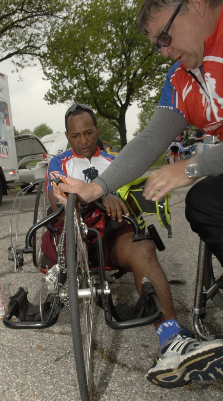Rick Leipole ensures Army Staff Sgt. Alfred Dela Santos'  bicycle is in top condition prior to participating in the Wounded Warrior Cycle Ride at Andrews Air Force Base on May 1, 2009. The wounded warriors rode from Andrews to Annapolis, MD., as a part of a four day event to raise awareness fo issues that veterans are challenged with when they return wounded from the war and for many, the soldier ride provides an important step in their return to an active lifestyle. (US Air Force photo by Senior Airman Keyonna Fennell)