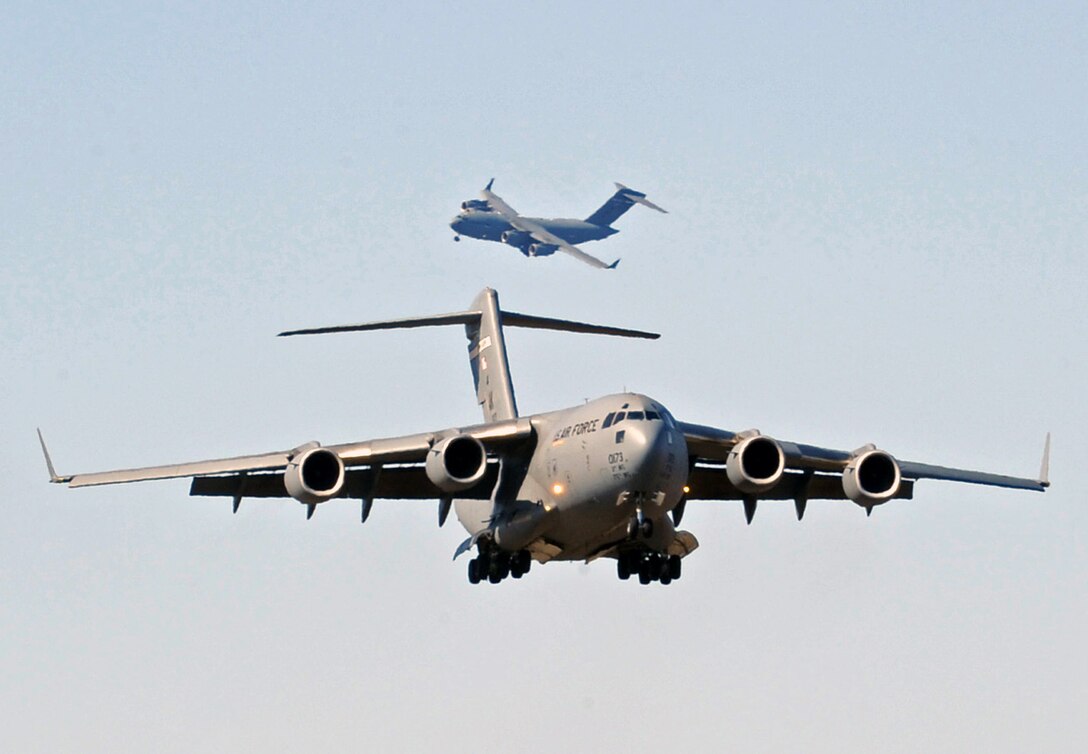 Two C-17 Globemaster IIIs prepare to land after participating in Red Flag-Alaska 2009 April 30 at Elmendorf Air Force Base, Alaska. This exercise enabled flying squadrons to enhance their fighting capabilities in simulated combat sorties in a realistic threat environment. The 10-day exercise ended May 1. (U.S. Air Force photo/Senior Airman Laura Turner) 
