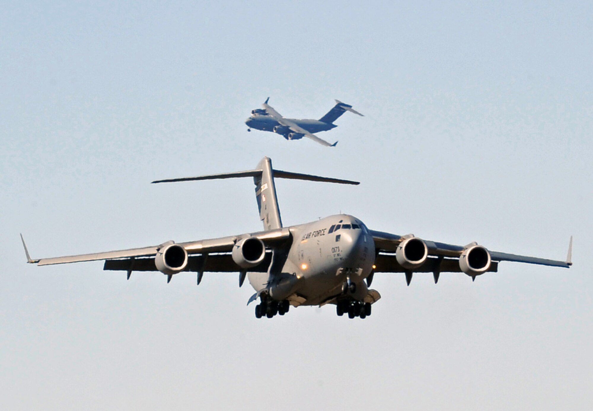 Two C-17 Globemaster IIIs prepare to land after participating in Red Flag-Alaska 2009 April 30 at Elmendorf Air Force Base, Alaska. This exercise enabled flying squadrons to enhance their fighting capabilities in simulated combat sorties in a realistic threat environment. The 10-day exercise ended May 1. (U.S. Air Force photo/Senior Airman Laura Turner) 
