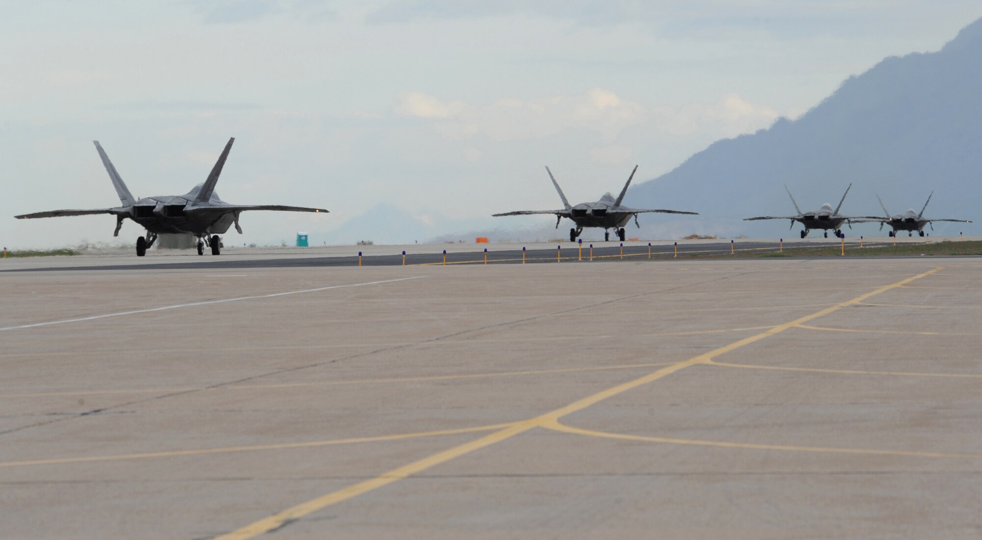F-22's from Holloman Air Force Base taxi down the flightline for take-off during Combat Hammer at Hill AFB, Utah, May 5. Combat Hammer performs sixty-five percent of there operations at the Utah Test and Training Range.  (U.S. Air Force photo/Senior Airman Michael Means)