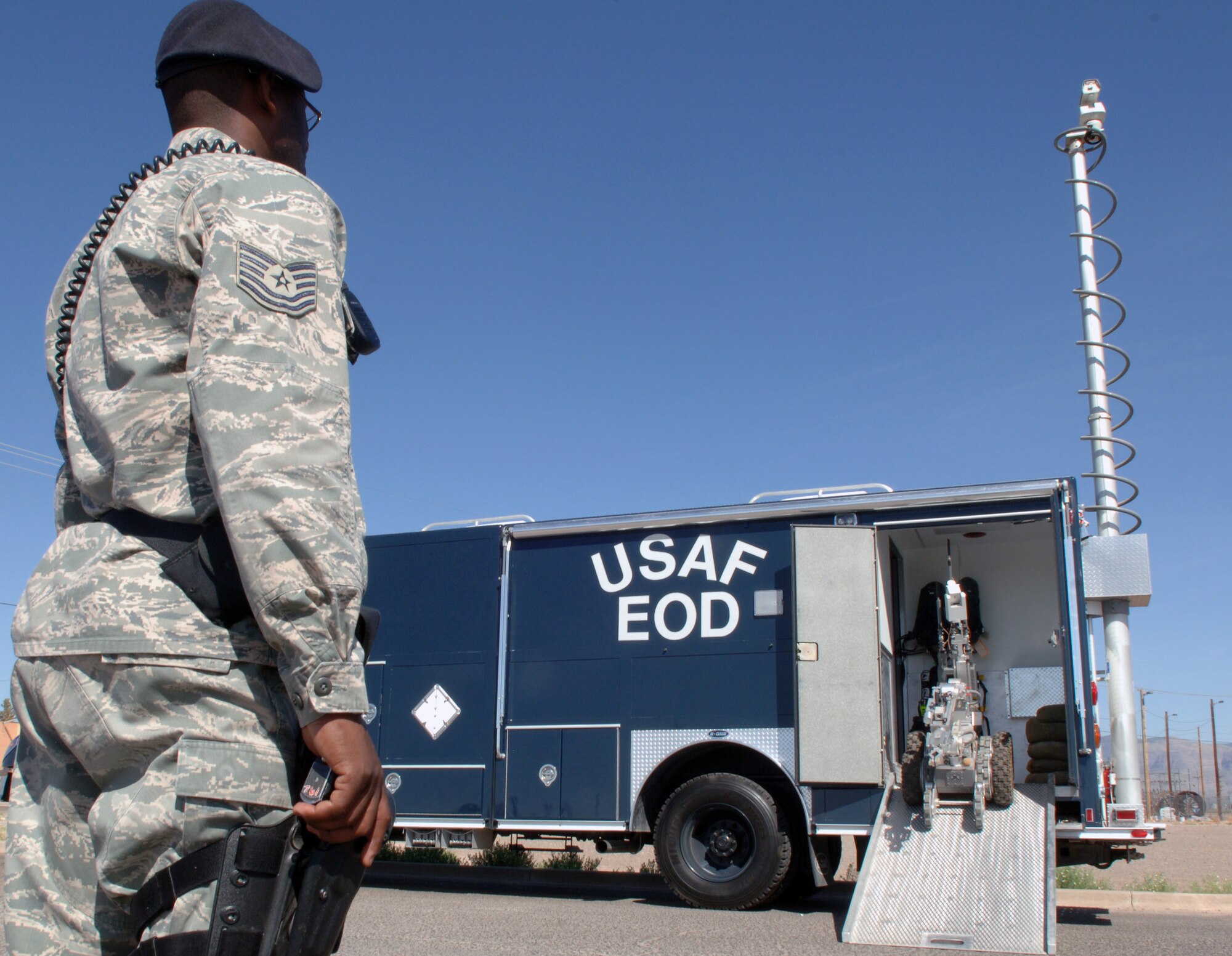 Technical Sgt. Vincent Hamilton, 49th Security Forces Squadron flight chief, looks on as the HD-1 robot “Wolverine” mechanically reverses into the EOD truck during a base exercise at Holloman Air Force Base, N.M., April 29. Sergeant Hamilton and other security forces members were on scene to maintain the perimeters and prevent anyone from entering the blocked area. (U.S. Air Force photo/ Airman 1st Class Veronica Stamps)