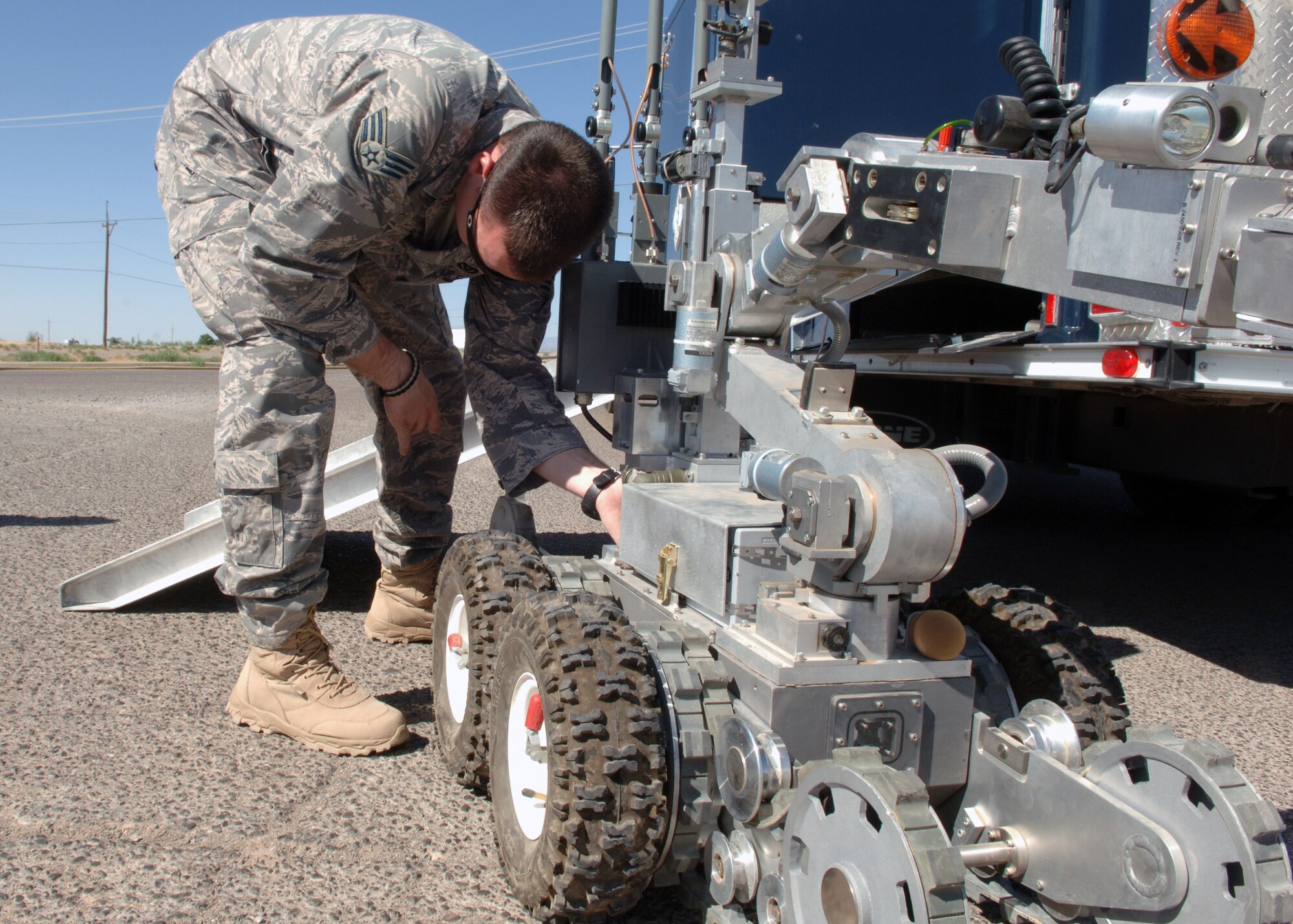 Senior Airman Colby Nokes, 49th Civil Engineering Squadron/ Expolsive Ordinance Disposal, prepares the HD-1  robot “Wolverine” to load inside of the EOD truck at Holloman Air Force Base, N.M., April 29. The 49 CES/EOD conducted a training exercise to practice emergency response to threats from improvised explosive devices. (U.S. Air Force photo/ Airman 1 Class Veronica Stamps) 