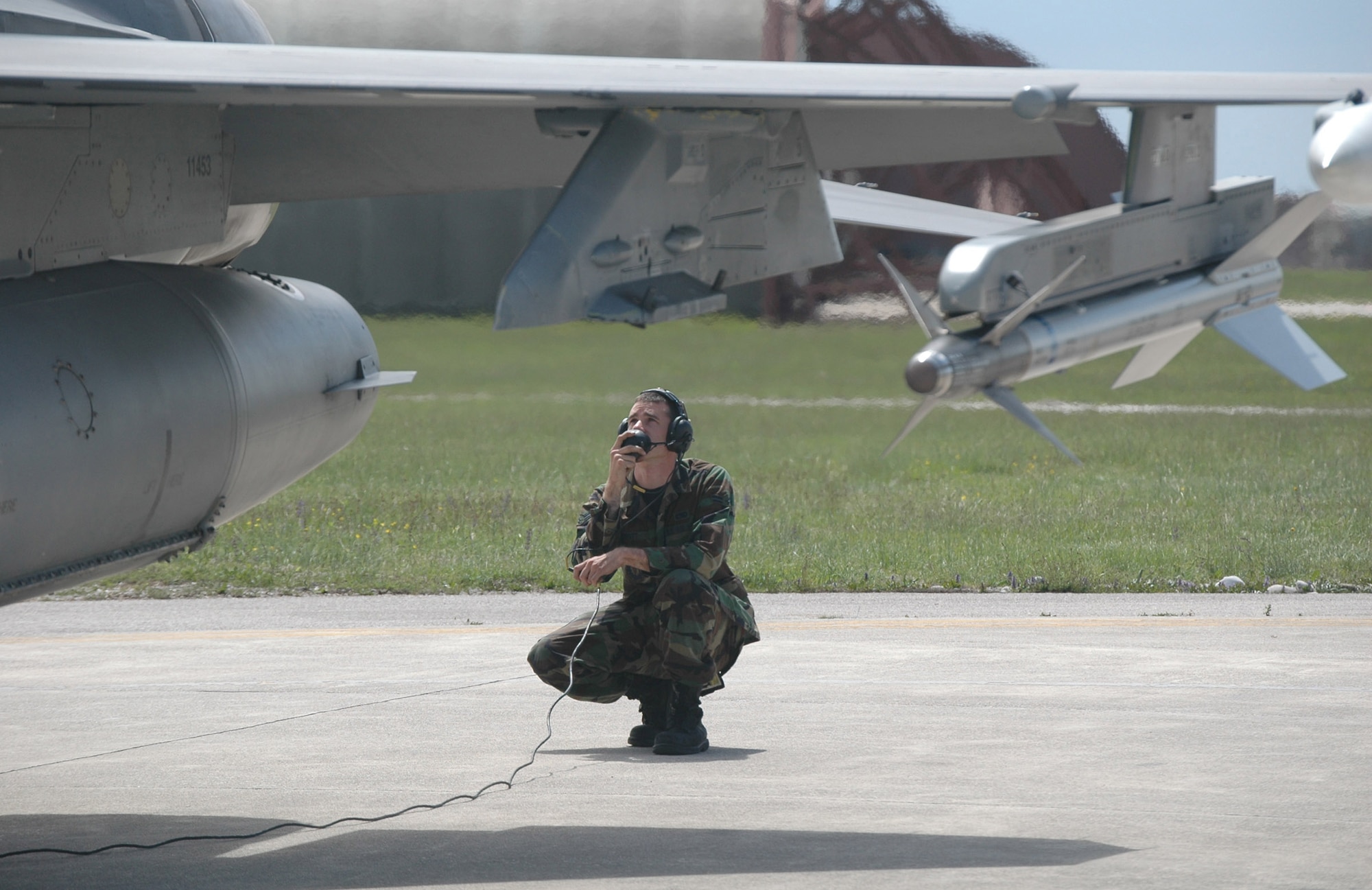 Airman 1st Class Richard Sprott, 31st Aircraft Maintenance Squadron crew chief, runs through a preflight check on F-16 tail number 2057 before it takes off on the mission that will surpass its 7,000 flying-hour mark May 5, 2009. This is the first jet in the Aviano fleet to reach this milestone. (U.S. Air Force photo/Staff Sgt. Lindsey Maurice)