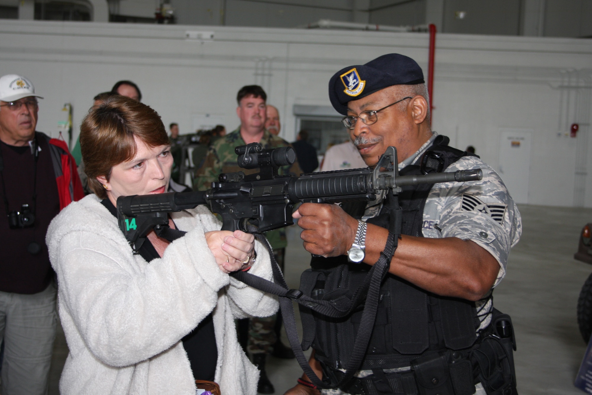 WRIGHT-PATTERSON AIR FORCE BASE, Ohio – Tech. Sgt. Mike Pennington, 445th Security Forces Squadron, shows Susan Patton, VA Medical Center, the various weapons used in the security forces squadron.  Seventy two employers of the 445th Airlift Wing reservists spent the day touring the wing with their reservists and flying on either a C-5 Galaxy or KC-10 Extender. (Air Force photo/Staff Sgt. Ken LaRock)