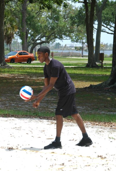 Airman 1st Class Denton Williams, 325th Security Forces Squadron member, prepares to serve during a volleyball game at Heritage Park in Tyndall Air Force Base, Fla., May 5. The volleyball game was hosted by 325 SFS to provide some extracurricular activity for 10 youths going through rehabilitation at the Liberty Unit for Specialized Treatment, a juvenile delinquency program located in Bristol, Fla. (U.S. Air Force photo/Staff Sgt. Joshua Stevens) 