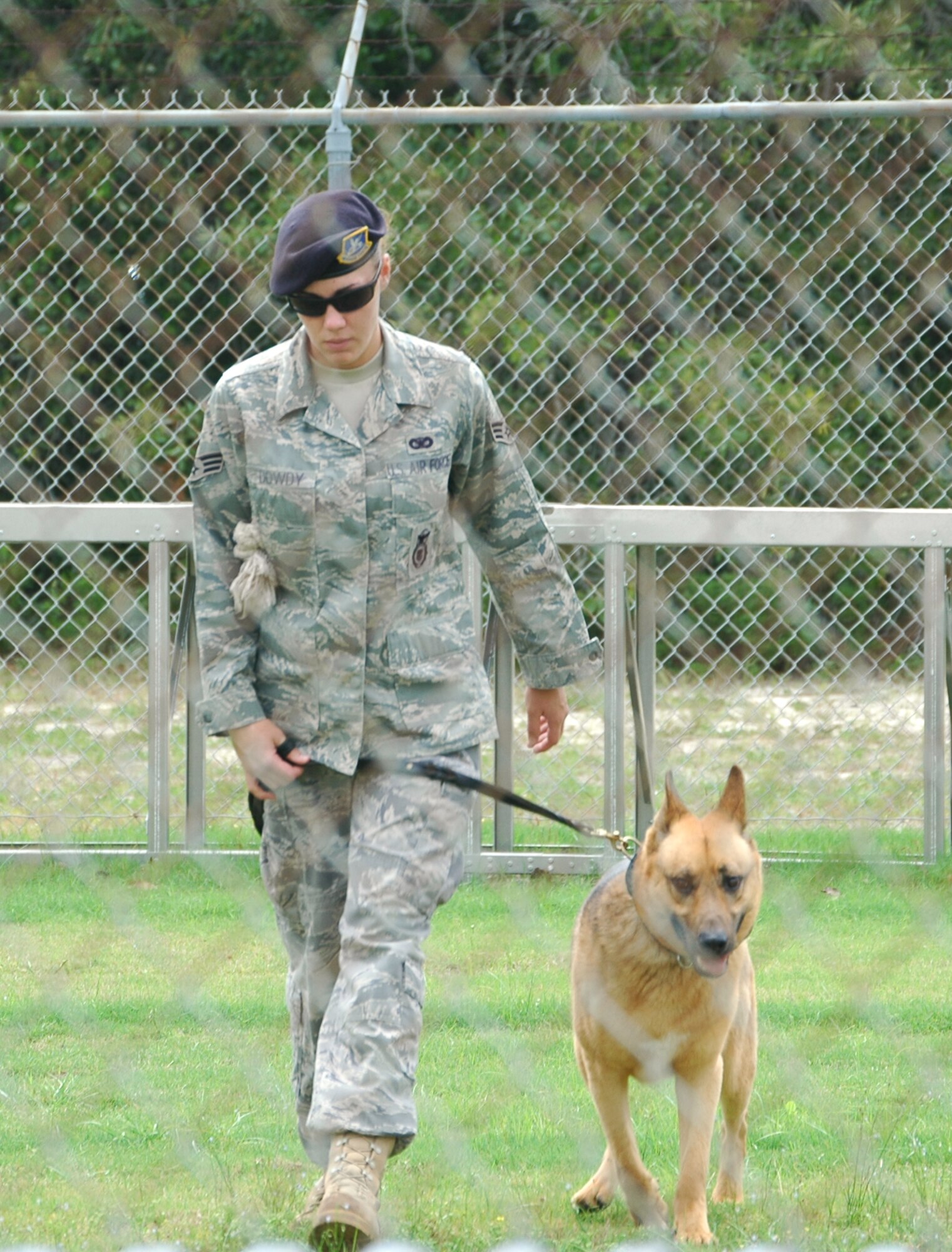Senior Airman Carrie Dowdy, 325th Security Forces Squadron military working dog handler, guides her dog, Ciro, a 7-year-old German shepherd, through a "march" routine to showcase his obedience May 5 at Tyndall Air Force Base, Fla. The audience for the demonstration was made up of youths from the juvenile delinquency program, Liberty Juvenile Unit for Specialized Treatment in Bristol, Fla. (U.S. Air Force photo/Staff Sgt. Joshua Stevens) 