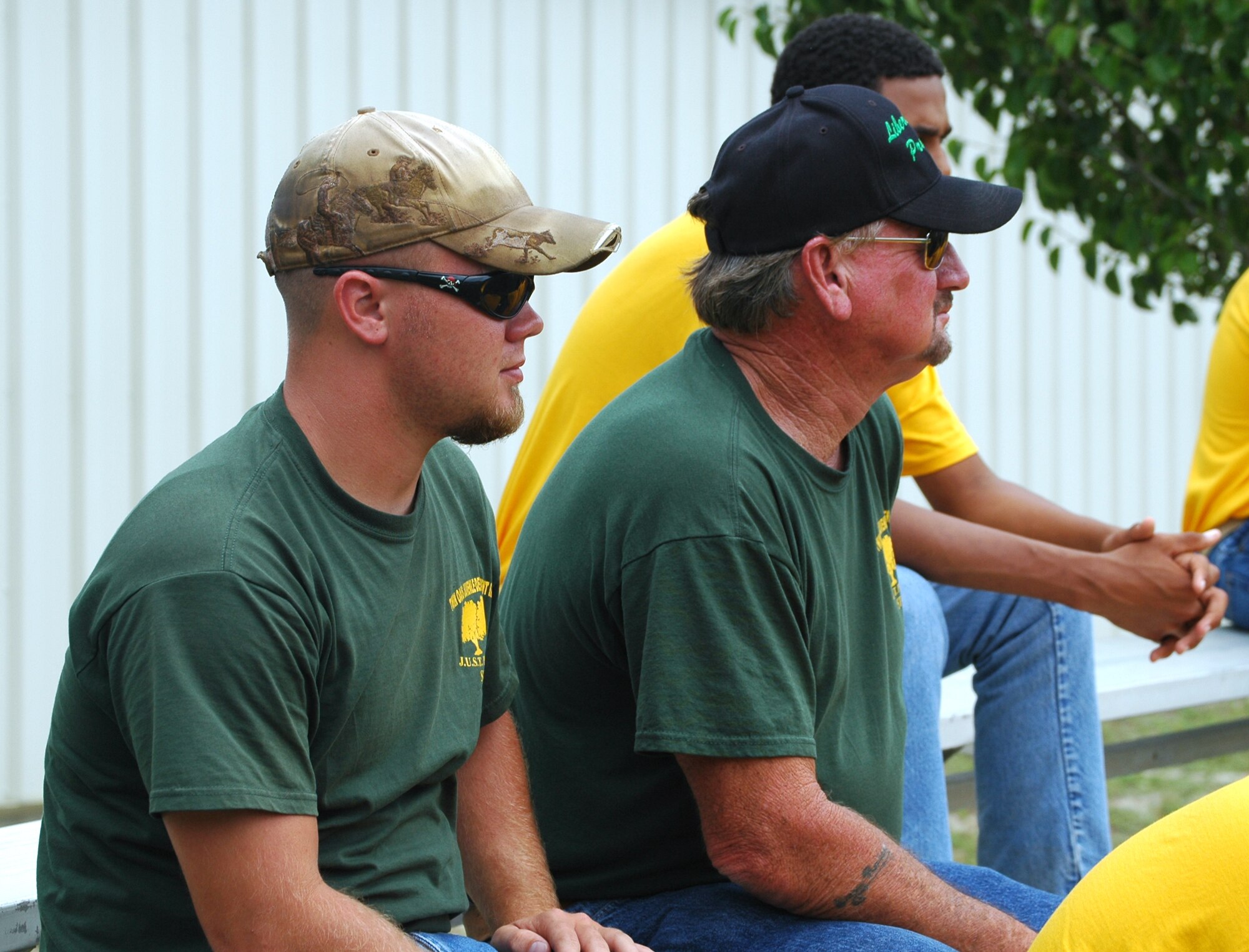 (Left) Ray Lasseter and Ernest Rayley, Liberty Juvenile Unit for Specialized Treatment team leaders, watch as members of the 325th Security Forces Squadron K-9 Unit, showcase one of the military working dog's skills May 5 at Tyndall Air Force Base, Fla. The two men escorted a group of 10 teenagers involved with their program who were chosen to tour the base due to their consistent good behavior through the boys' rehabilitation. (U.S. Air Force photo/Staff Sgt. Joshua Stevens) 