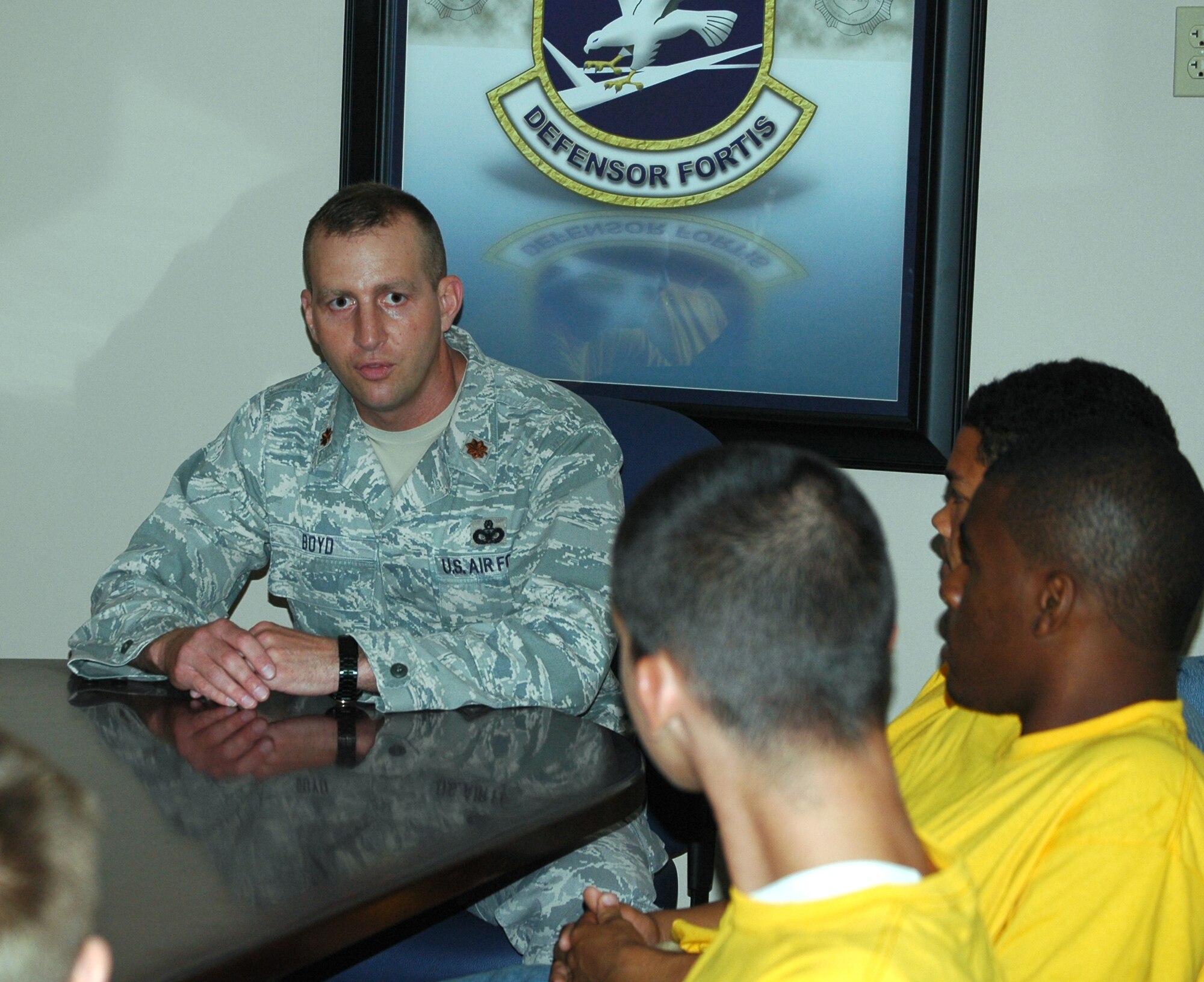 Maj. Woody Boyd, 325th Security Forces Squadron commander, talks to teenagers from the Liberty Juvenile Unit for Special Treatment, a juvenile delinquency facility, about the mission of the 325 SFS May 5 at Tyndall Air Force Base, Fla. The squadron hosted the teens for a day of touring the base and mentoring the youths. The purpose of the visit was to show the boys positive paths to goals later in life. (U.S. Air Force photo/Staff Sgt. Joshua Stevens) 