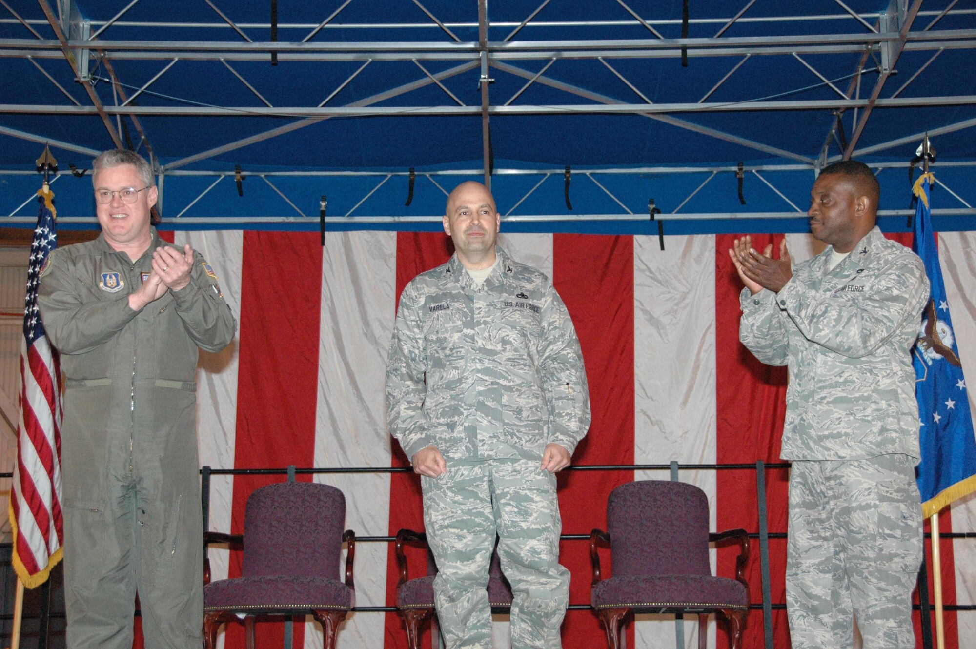 MCGUIRE AIR FORCE BASE, N.J. -- Newly installed 514th Maintenance Group Commander, Col. Oreste Varela, center, receives a standing ovation led by Col. James L. Kerr, commander, 514th Air Mobility Wing and Col. Reginald Stroud, outgoing 514th Maintenance Group commander. The change in leaders took place May 3 in a change-of-command ceremony held here. (U.S. Air Force photo/Master Sgt. Donna T. Jeffries)