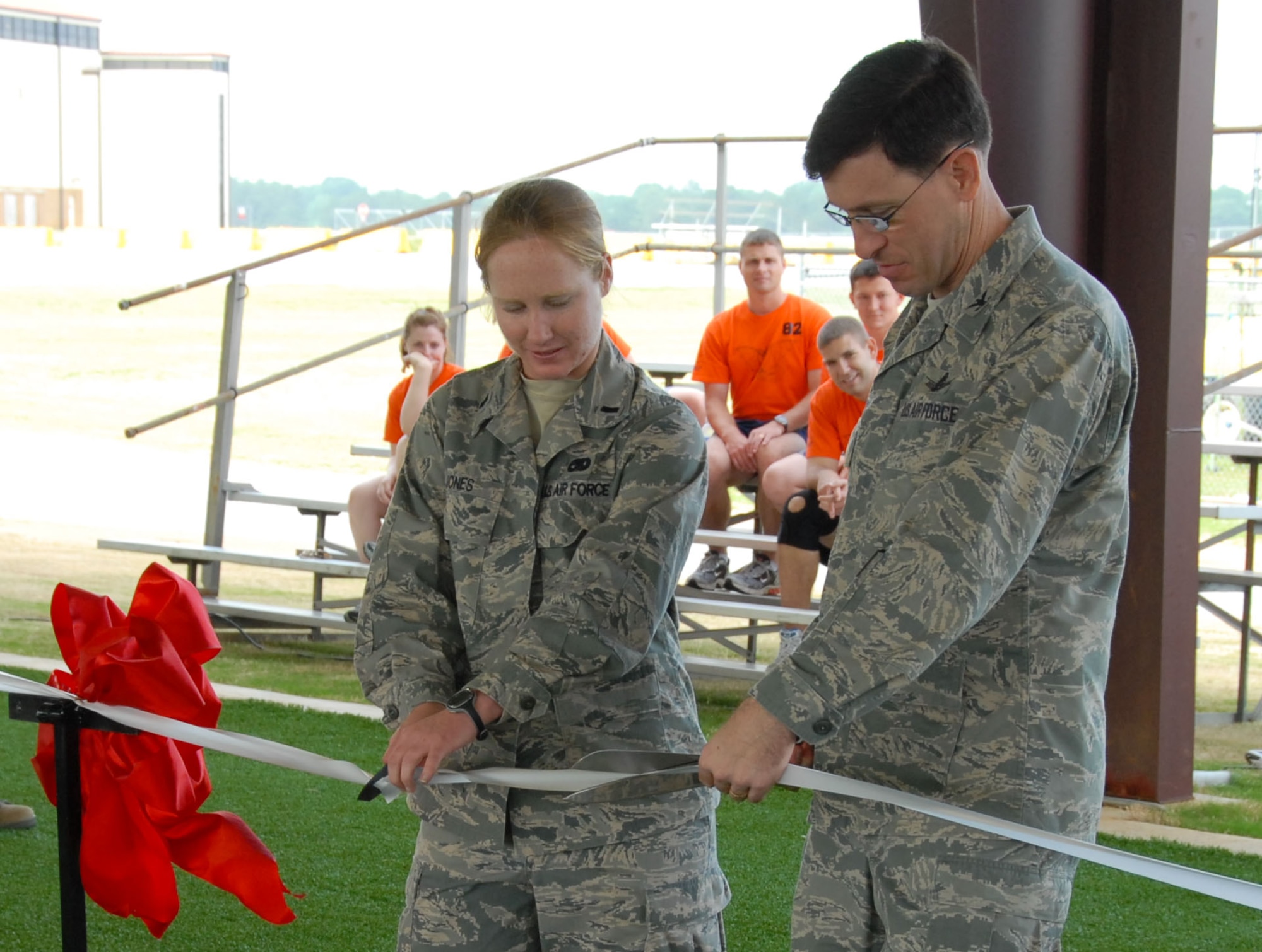 Col. Stephen Tanous, Squadron Officer College commandant, and 1st Lt. Kristen Jones, the youngest course instructor at the Air and Space Basic Course, cut the ribbon at the opening of ASBCs new Expeditionary Training Complex May 1. Afterwards, an Air Force combatives performance was conducted by ASBC instructors and students. (U.S. Air Force photo by Jamie Pitcher)