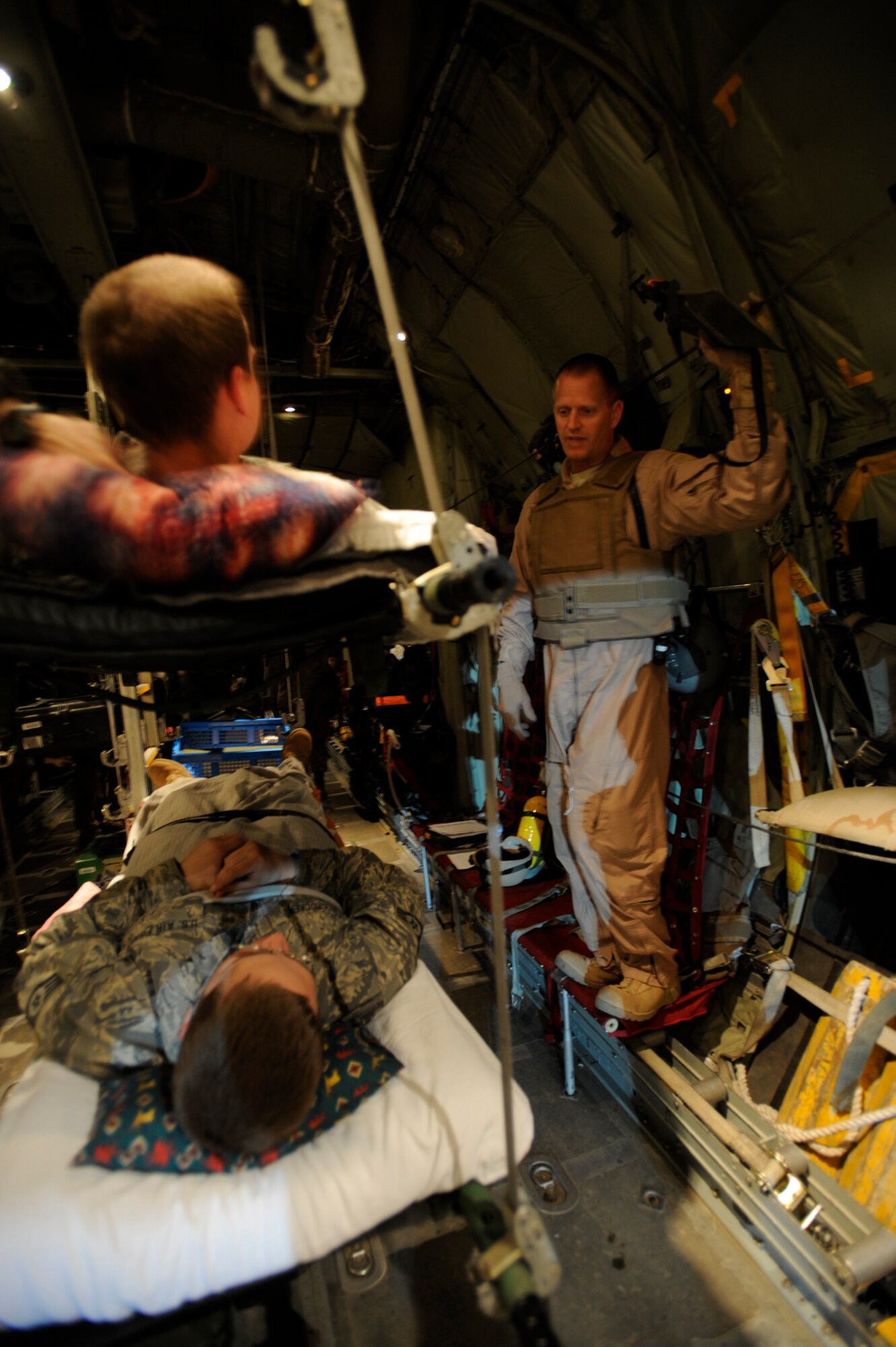 U.S. Air Force Maj. Scott Wilber, a flight nurse from the 379th Expeditionary Aeromedical Evacuation Squadron, Southwest Asia, gives a flight brief to patients aboard a C-130 Hercules during aeromedical operations on April 23, 2009, in support of Operation Enduring Freedom.  (U.S. Air Force photo by Staff Sgt. James L. Harper Jr.)Released