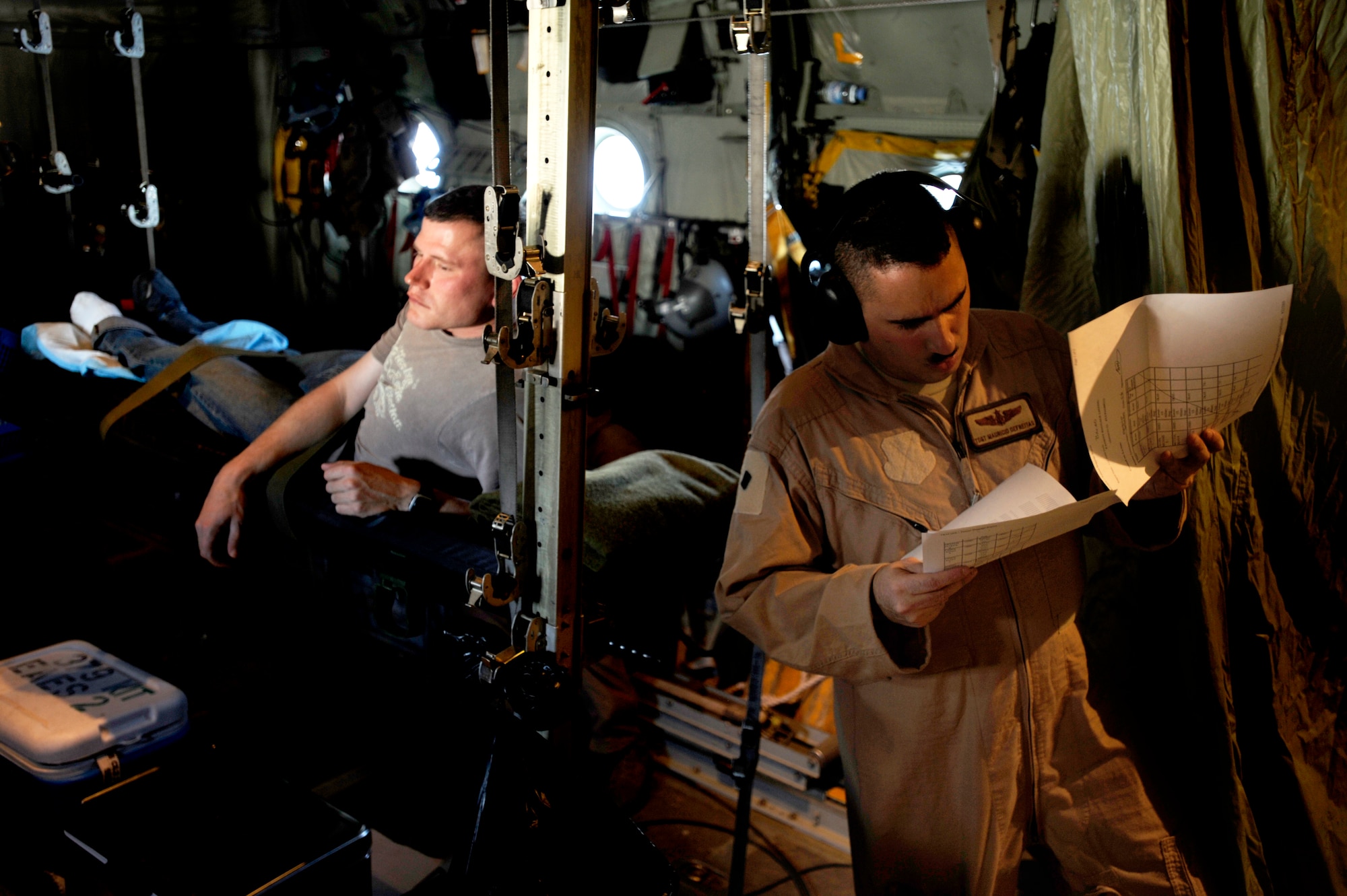U.S. Air Force Tsgt Mauricio Defreitas, a flight medical technician from the 379th Expeditionary Aeromedical Evacuation Squadron, Southwest Asia, reviews medical records during aeromedical operations on April 23, 2009, in support of Operation Iraqi Freedom.  (U.S. Air Force photo by Staff Sgt. James L. Harper Jr.)Released