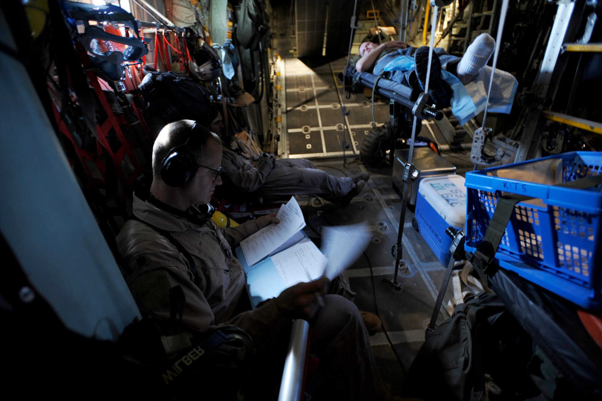 U.S. Air Force Maj. Scott Wilber, a flight nurse from the 379th Expeditionary Aeromedical Evacuation Squadron, Southwest Asia, reviews medical records during aeromedical operations on April 23, 2009, in support of Operation Iraqi Freedom.  (U.S. Air Force photo by Staff Sgt. James L. Harper Jr.)Released
