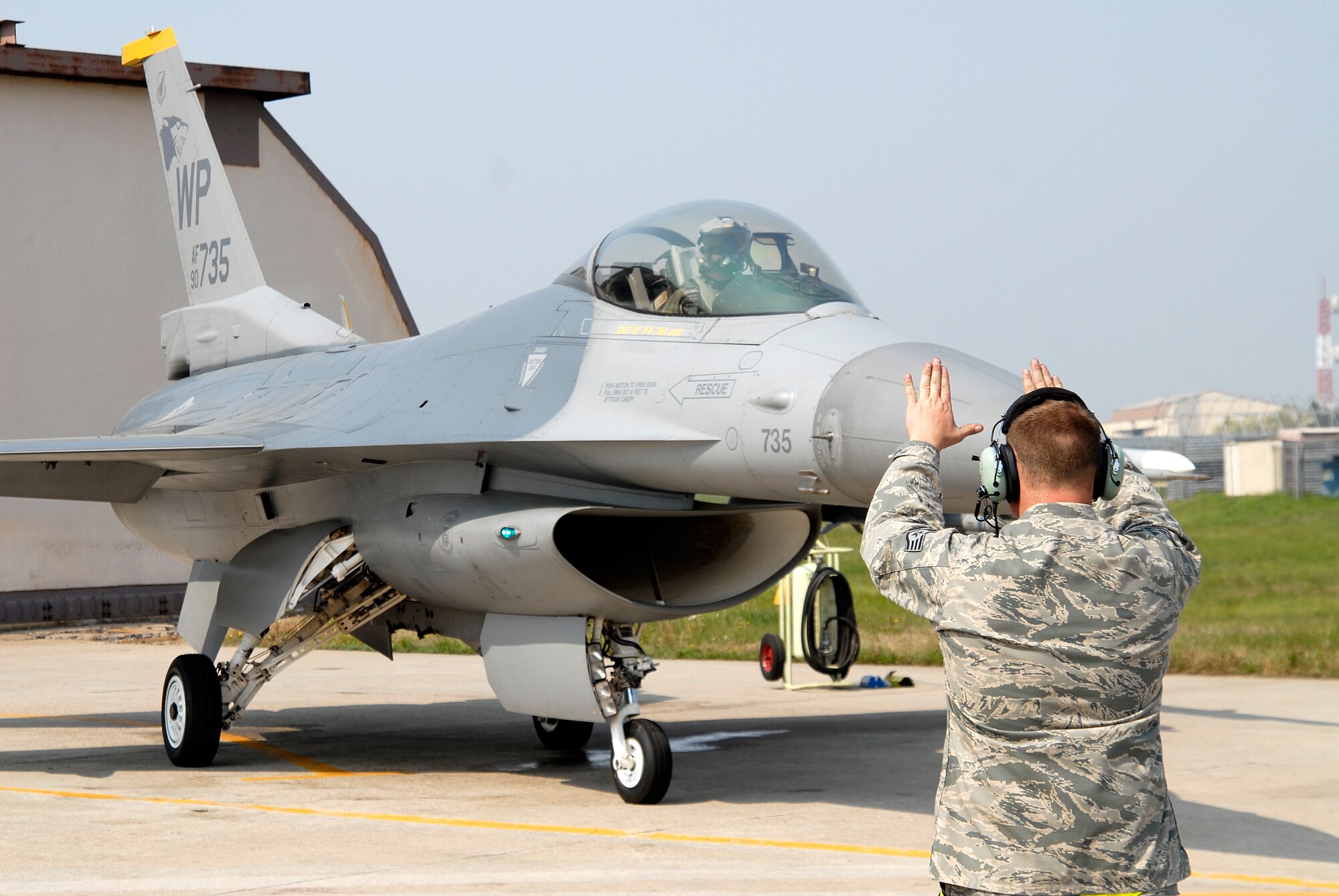 Staff Sgt Shaun Cecil, 8th Aircraft Maintenance Squadron crew chief, marshals out Lt. Gen. Jeff Remington, 7th Air Force commander, at Kunsan Air Base, Republic of Korea, May 6, 2009. General Remington came to Kunsan for a familiarization flight and an All-Call with the Airmen of the Wolf Pack. (U.S. Air Force Photo by SSgt Jason Colbert)

