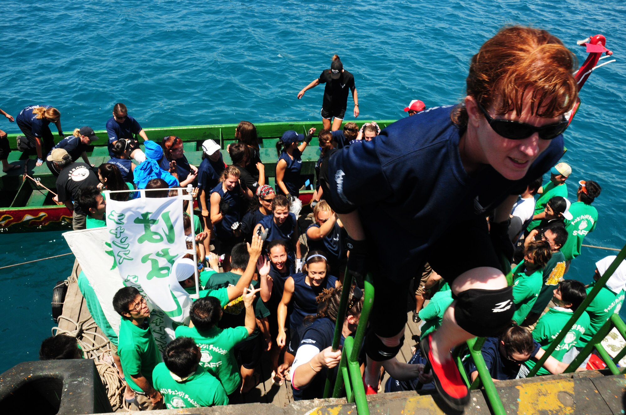 Kadena’s women's team step off the boat after winning their heat during the Dragon Boat race May 5 at Tomari Port in Naha City, Okinawa, Japan. The race, which caps off the week-long series of Japanese holidays called Golden Week, has been held annually for centuries in Okinawa. (U.S. Air Force photo/Airman 1st Class Amanda Grabiec)
