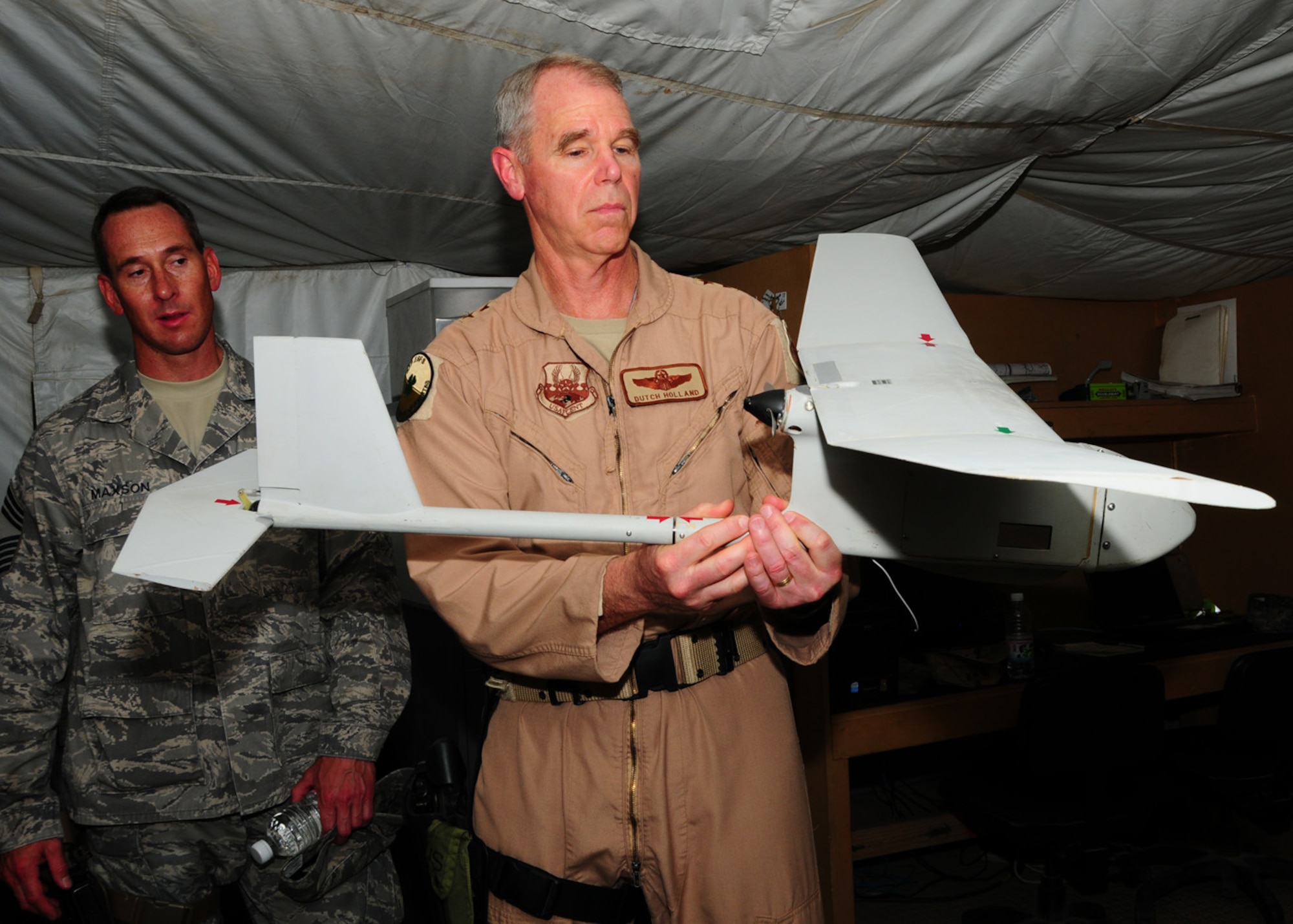 CAMP BUCCA, IRAQ -- Major Gen. William L. Holland, 9th Air Force vice commander and the deputy commander of U.S. Air Forces Central, takes a closer look at the Raven B unmanned aerial system during his visit to Camp Bucca, April 30. The Raven B is used by security forces Airmen for reconnaissance and surveillance, force protection, battle damage assessment and convoy security missions. (U.S. Air Force photo/ Senior Airman Courtney Richardson)