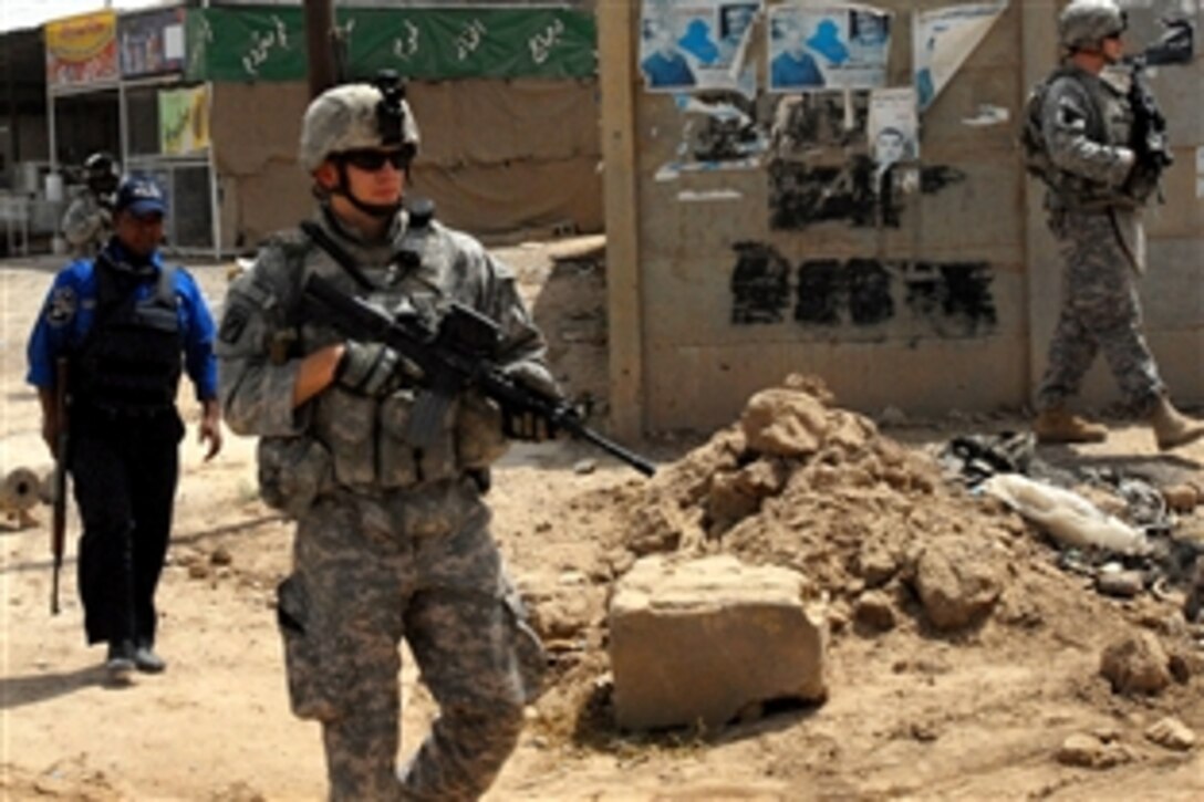 U.S. Army Spc. Adam Feldon, center, patrols with other soldiers and an Iraqi police officer through Taji market north of Baghdad, Iraq, May 4, 2009. The U.S. soldiers, assigned to Company C, 1st Battalion, 112th Infantry Regiment, 56th Stryker Brigade Combat Team, routinely patrol the market with Iraqi security forces to improve security for residents and shoppers. 